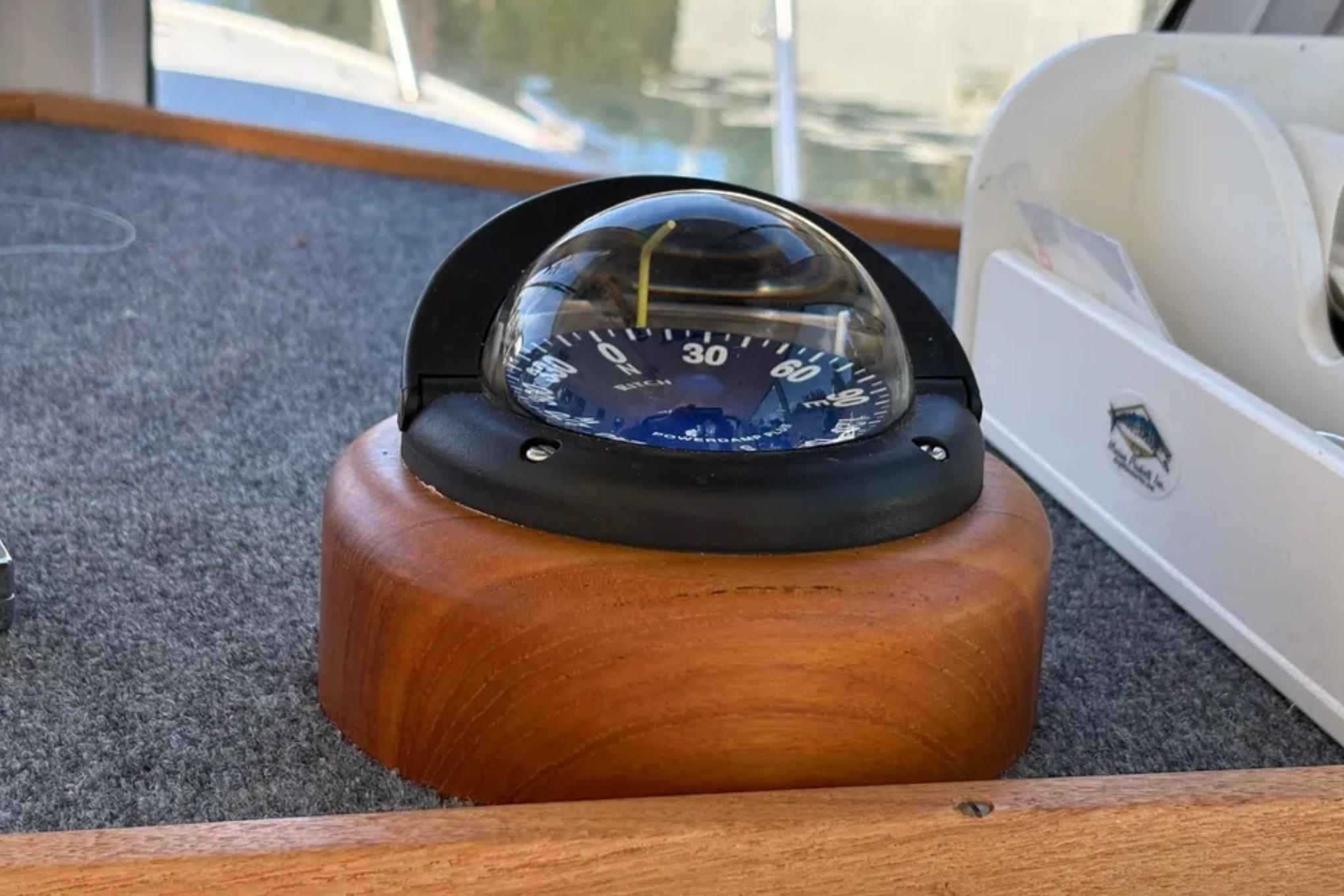 Compass on 2005 Albin 28 Tournament Express boat, mounted on wooden base.