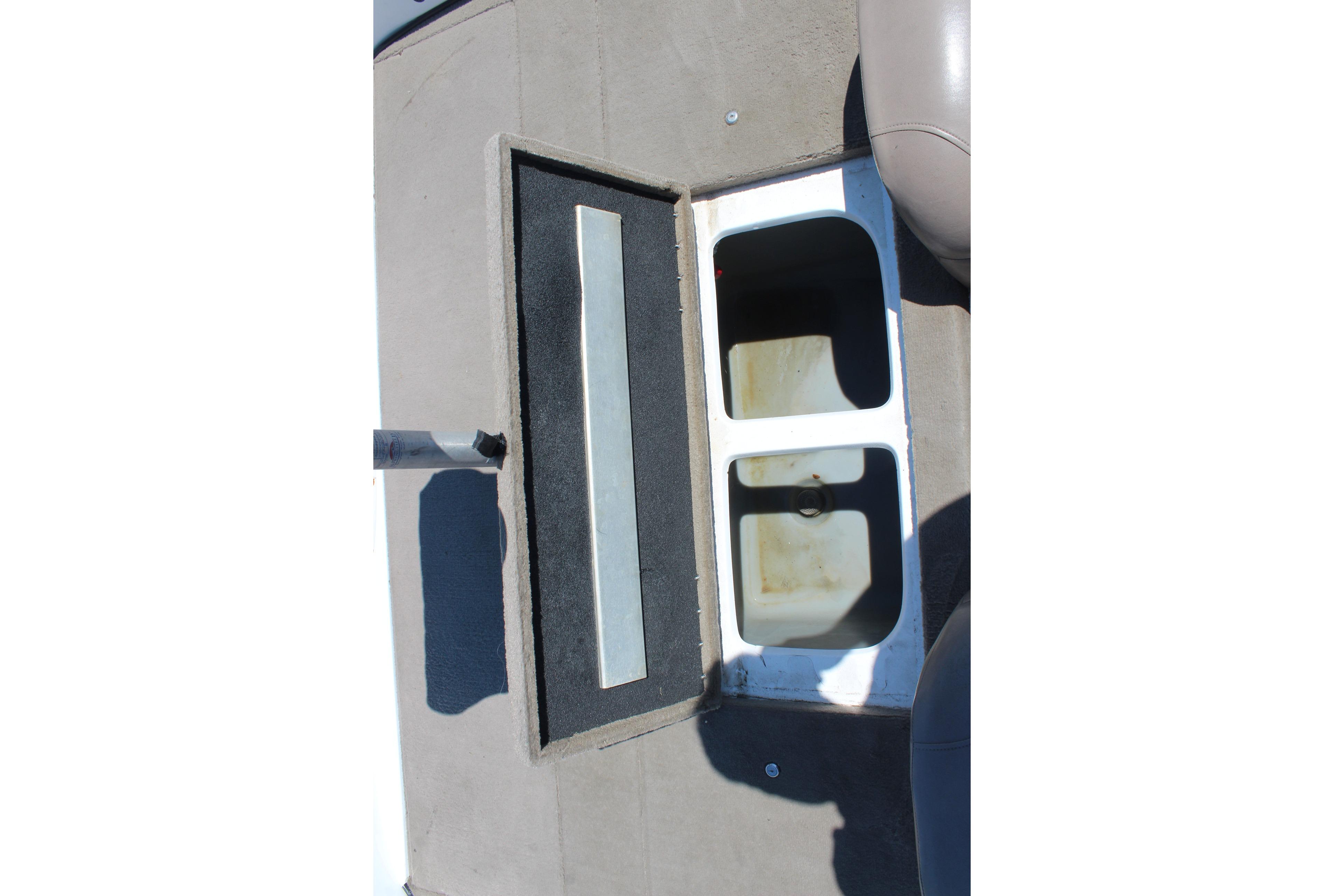 2003 Nitro NX 750 SC boat storage compartments with open lids.