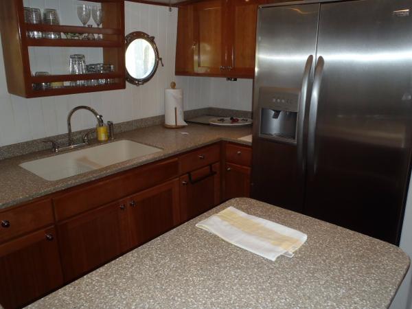 Modern kitchen in 2025 Great Harbour N40 yacht with stainless steel appliances and wooden cabinetry.