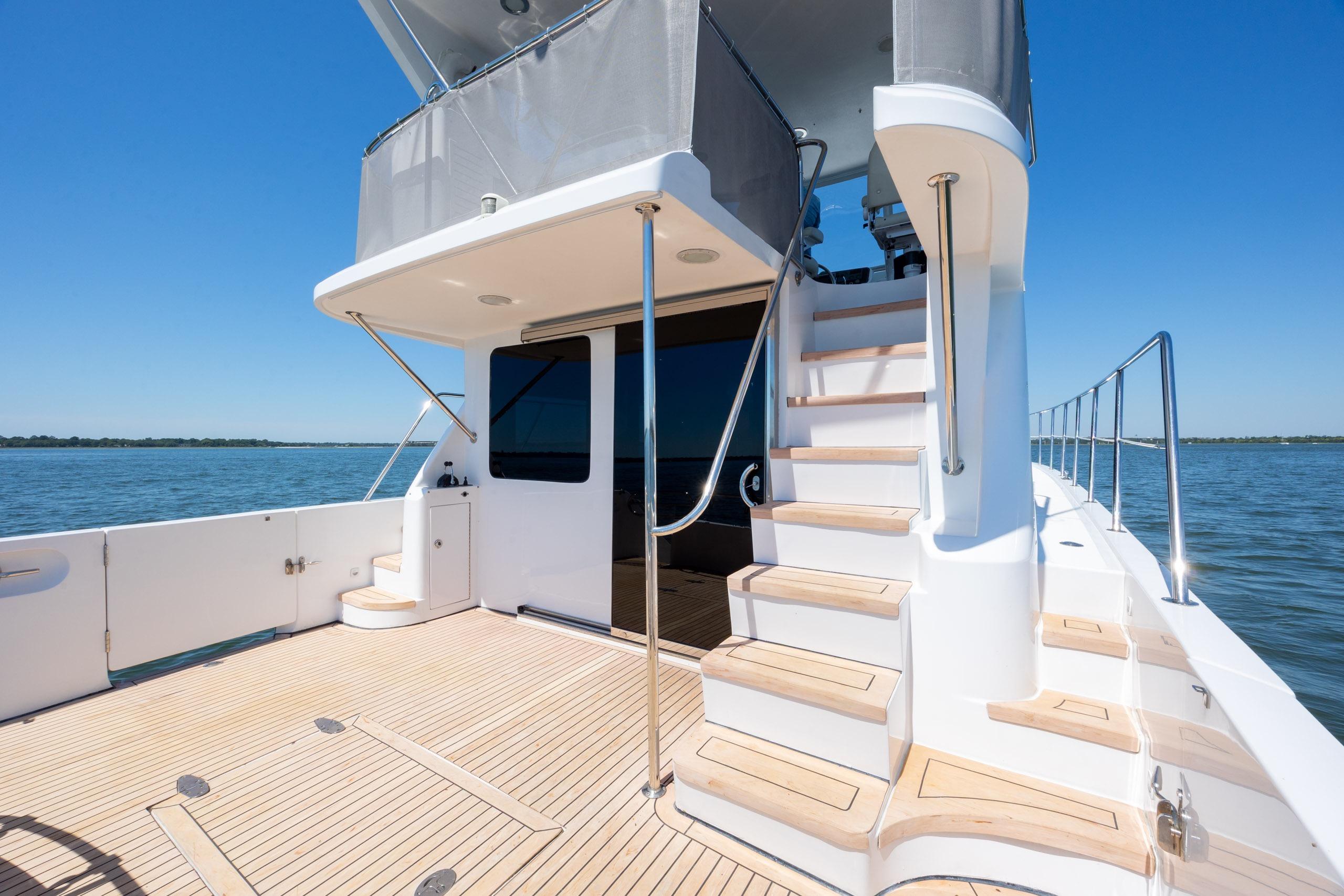 2005 Ocean Alexander 52 Sedan yacht deck with stairs, overlooking calm waters.