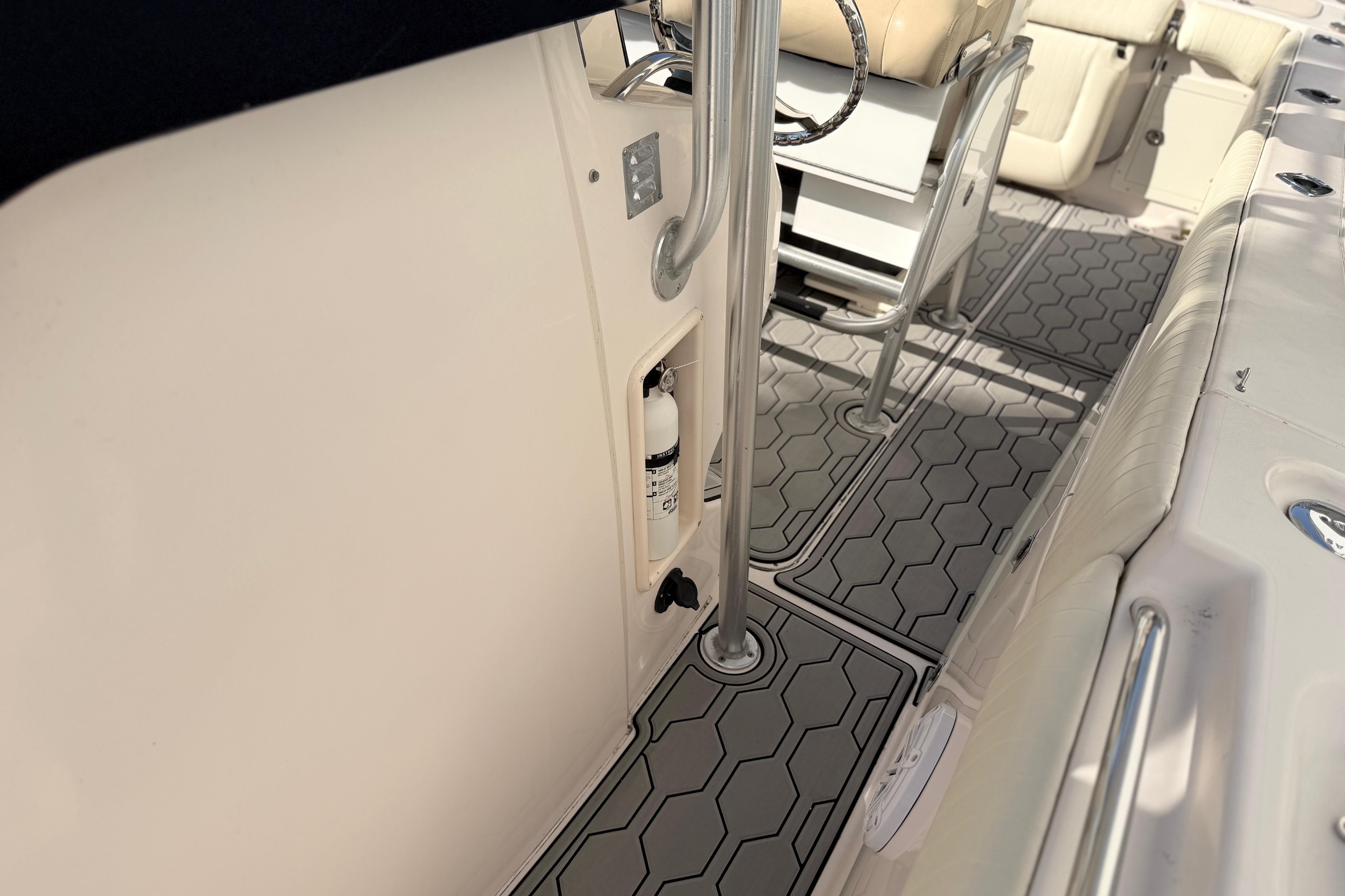 Interior of 2004 Grady White 273 boat with hexagonal patterned flooring and seating.