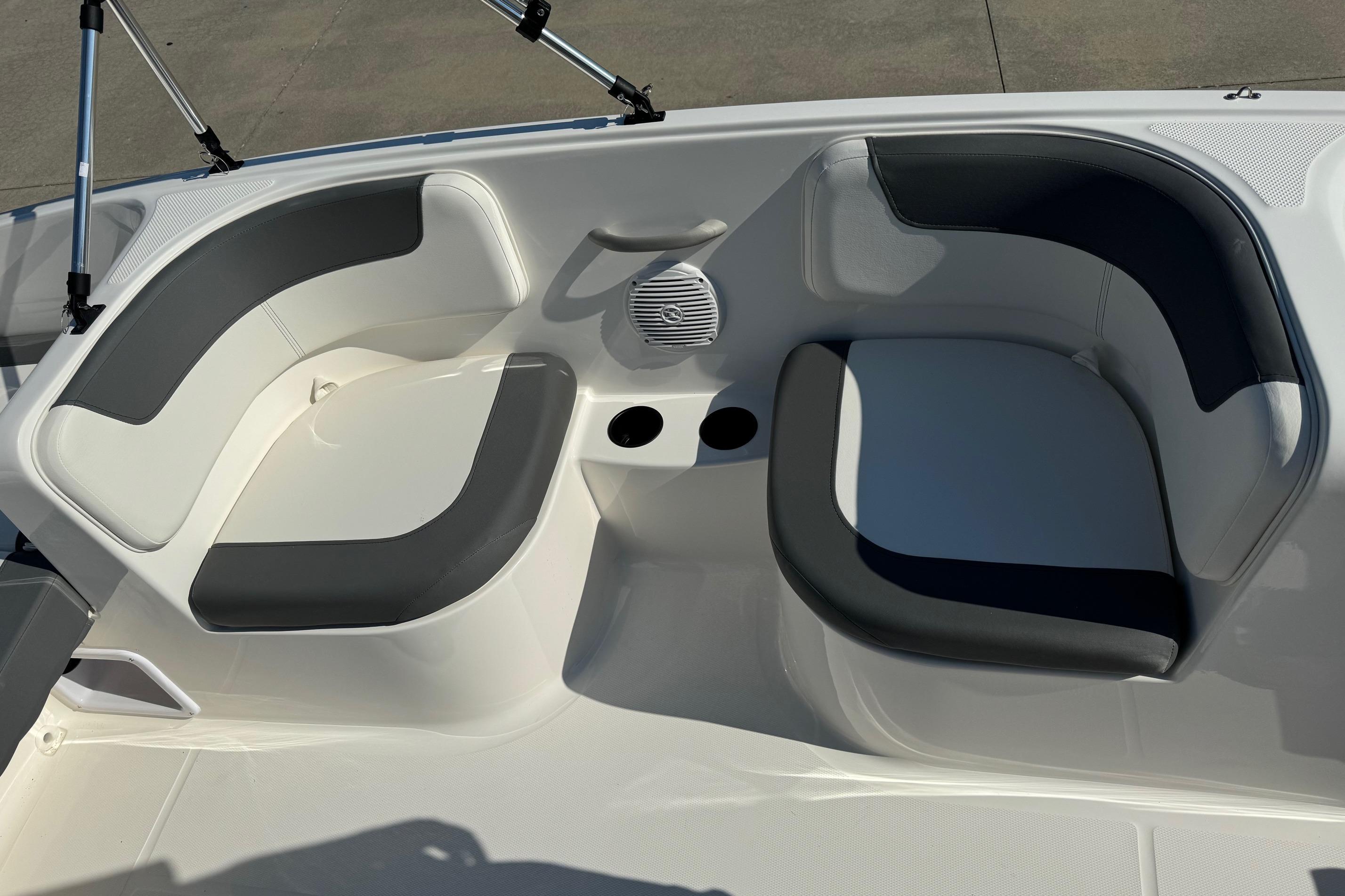 2025 Bayliner Element E16 boat seating area with cup holders and speaker.