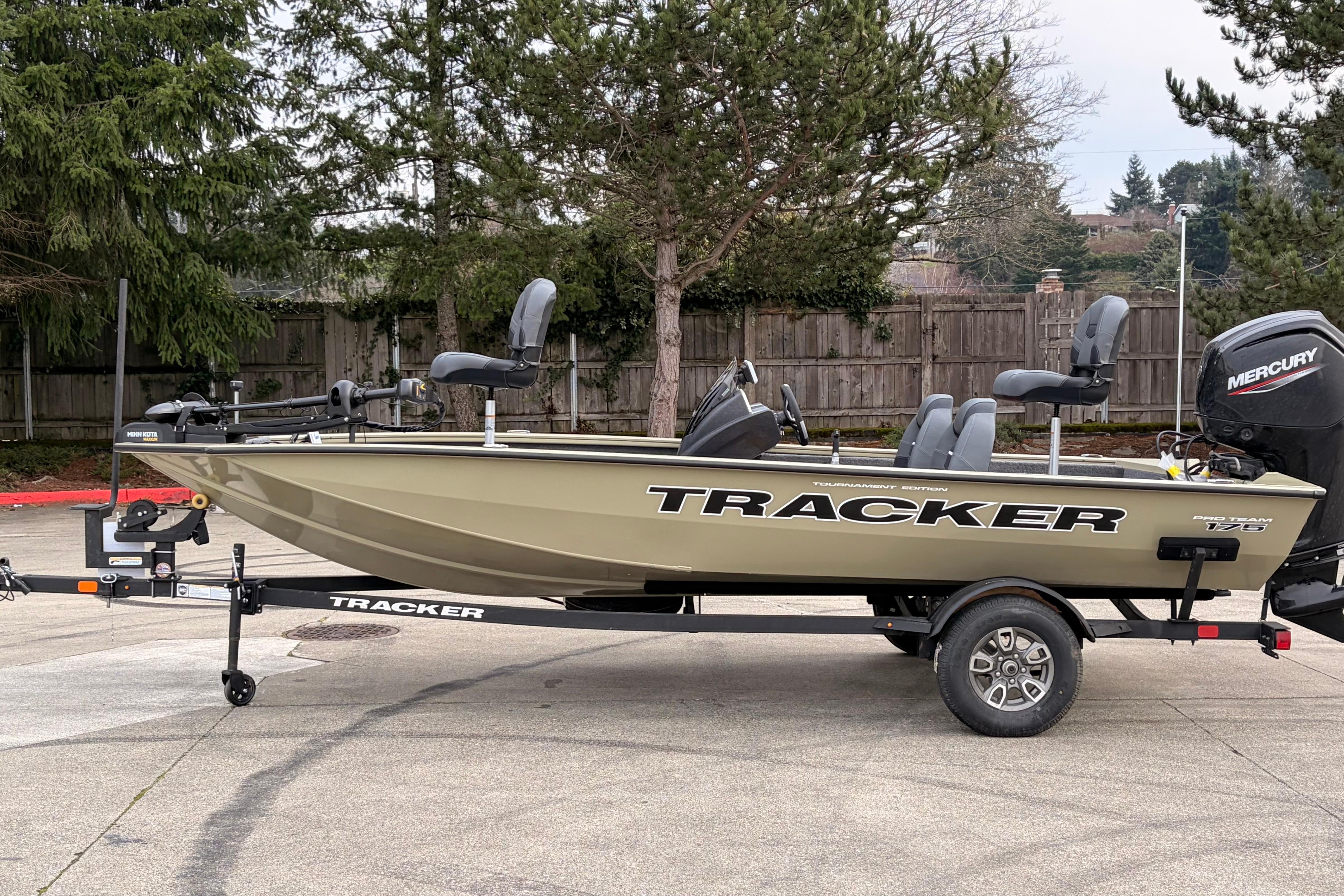 2026 Tracker Pro Team 175 boat on trailer, parked outdoors, featuring Mercury engine.