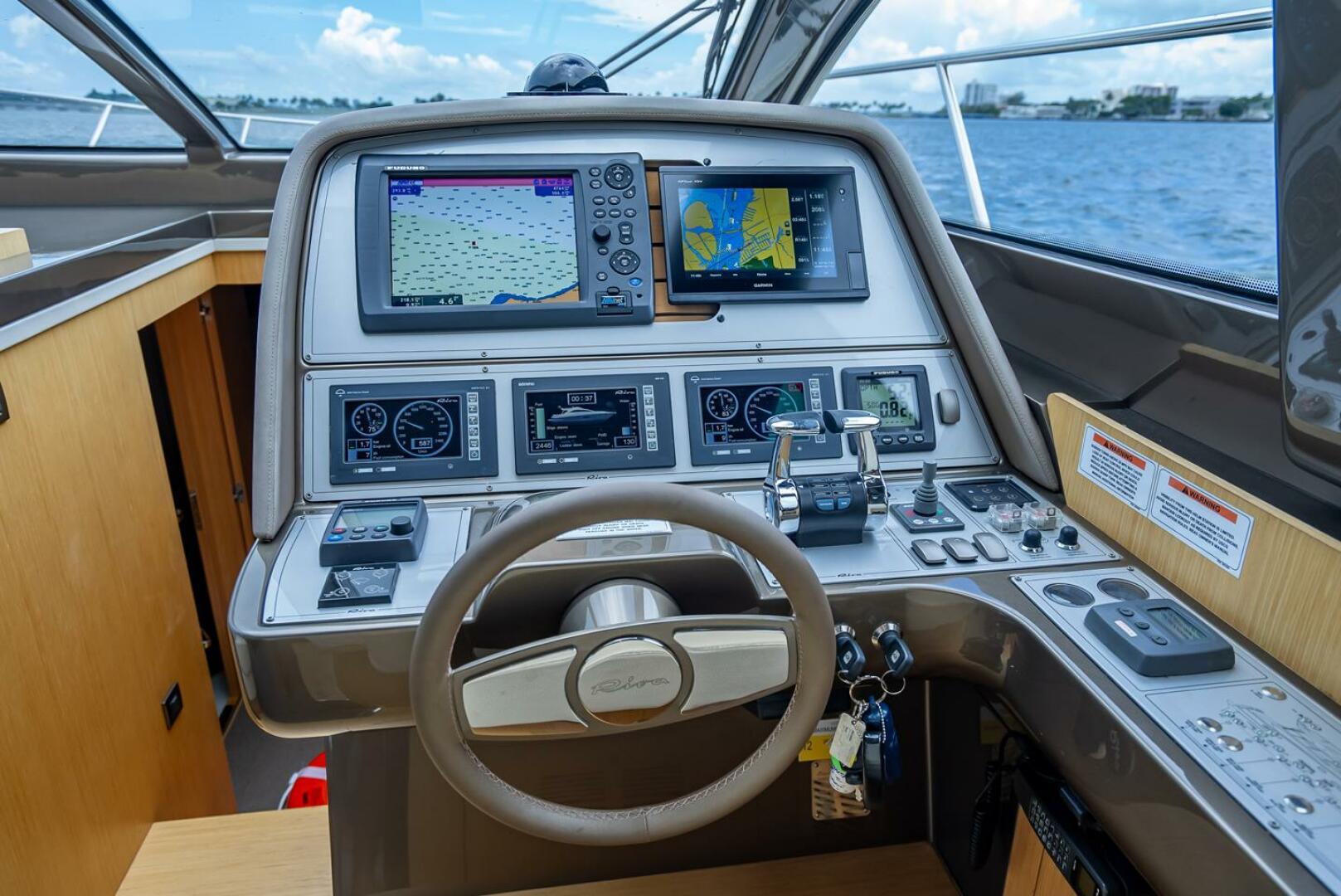 Cockpit of 2012 Riva Sport 56 yacht with navigation screens and controls.