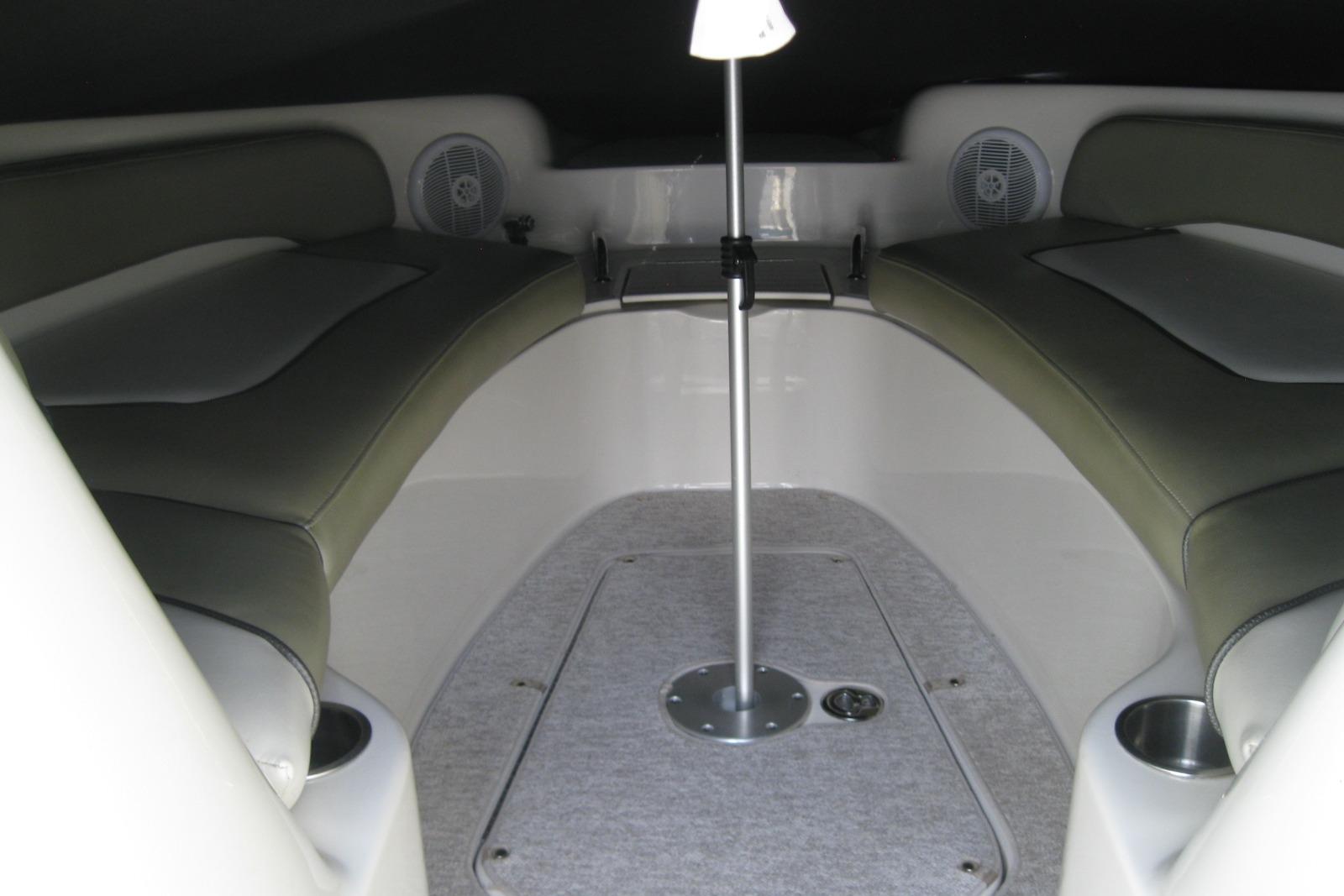 Interior view of a 2006 Sea Ray 240 Sundeck boat with cushioned seating.