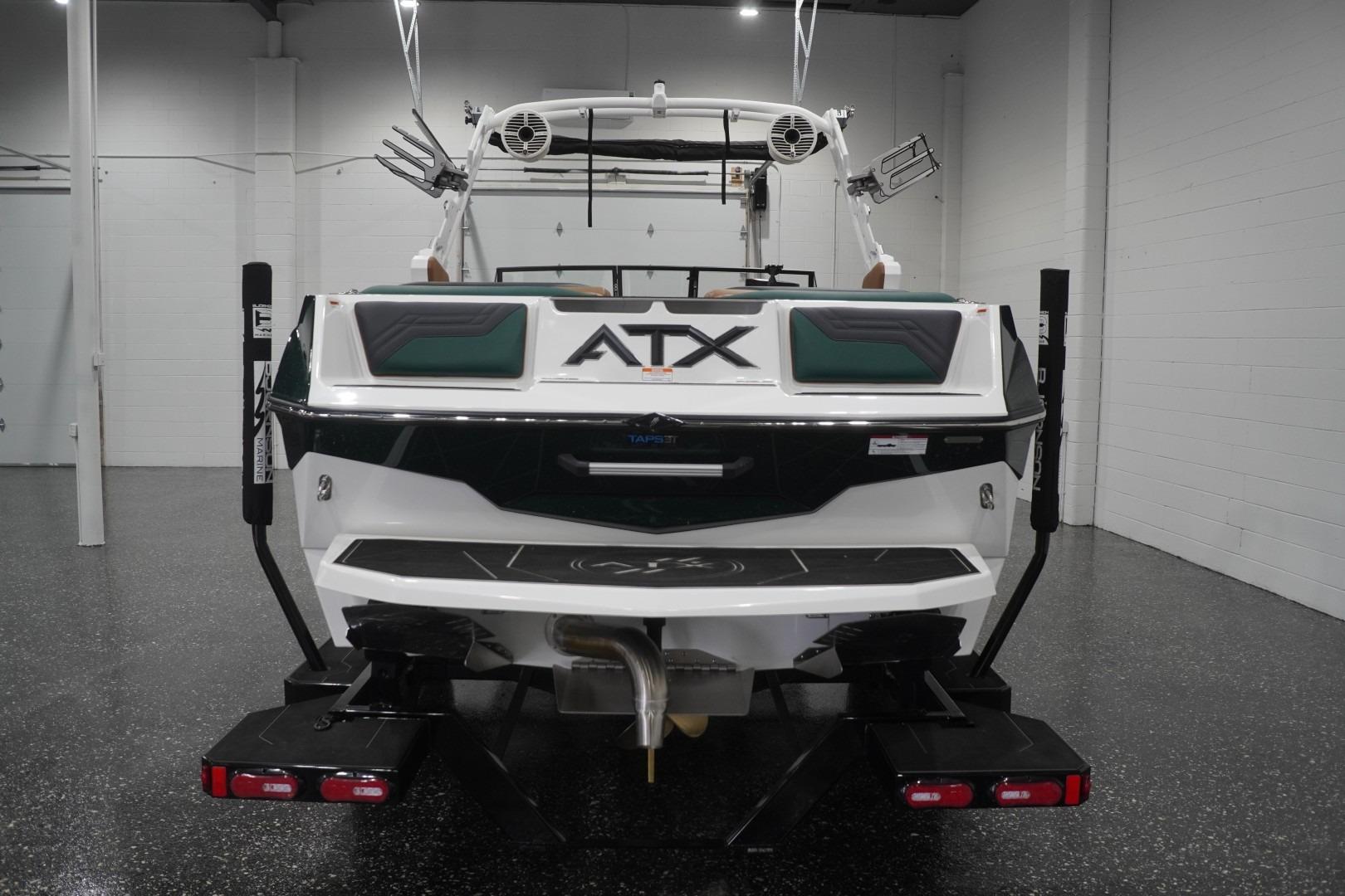 2025 ATX Surf Boats 24 Type-S in showroom, rear view with sleek design.