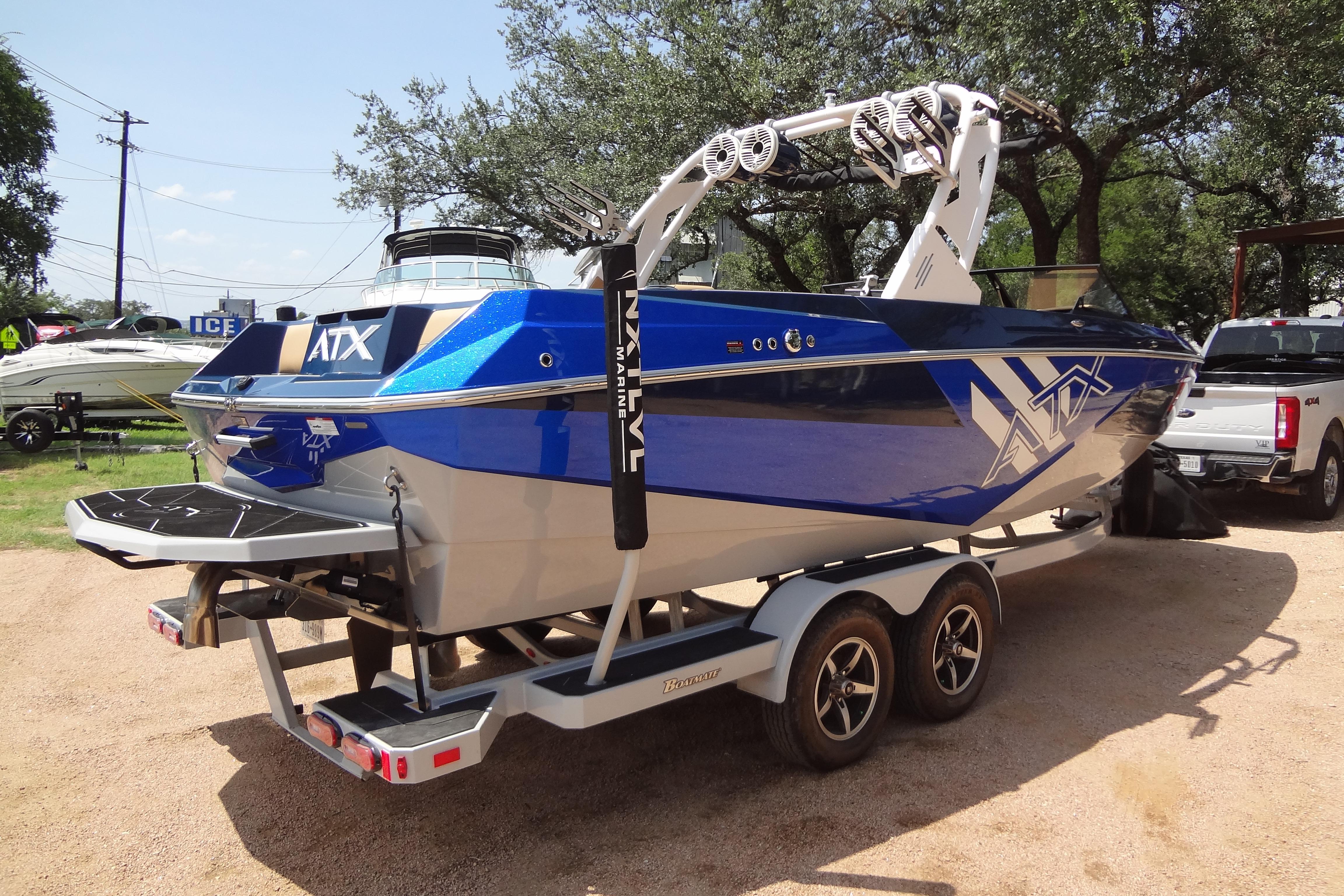 2022 ATX Surf Boats 24 Type-S in blue, parked on a trailer outdoors.