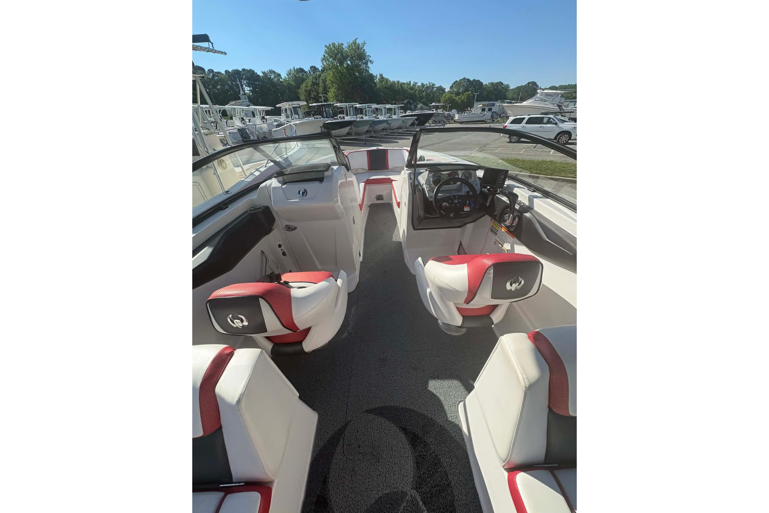 2016 Scarab 255 H.O. Impulse boat interior with red and white seating, steering console.