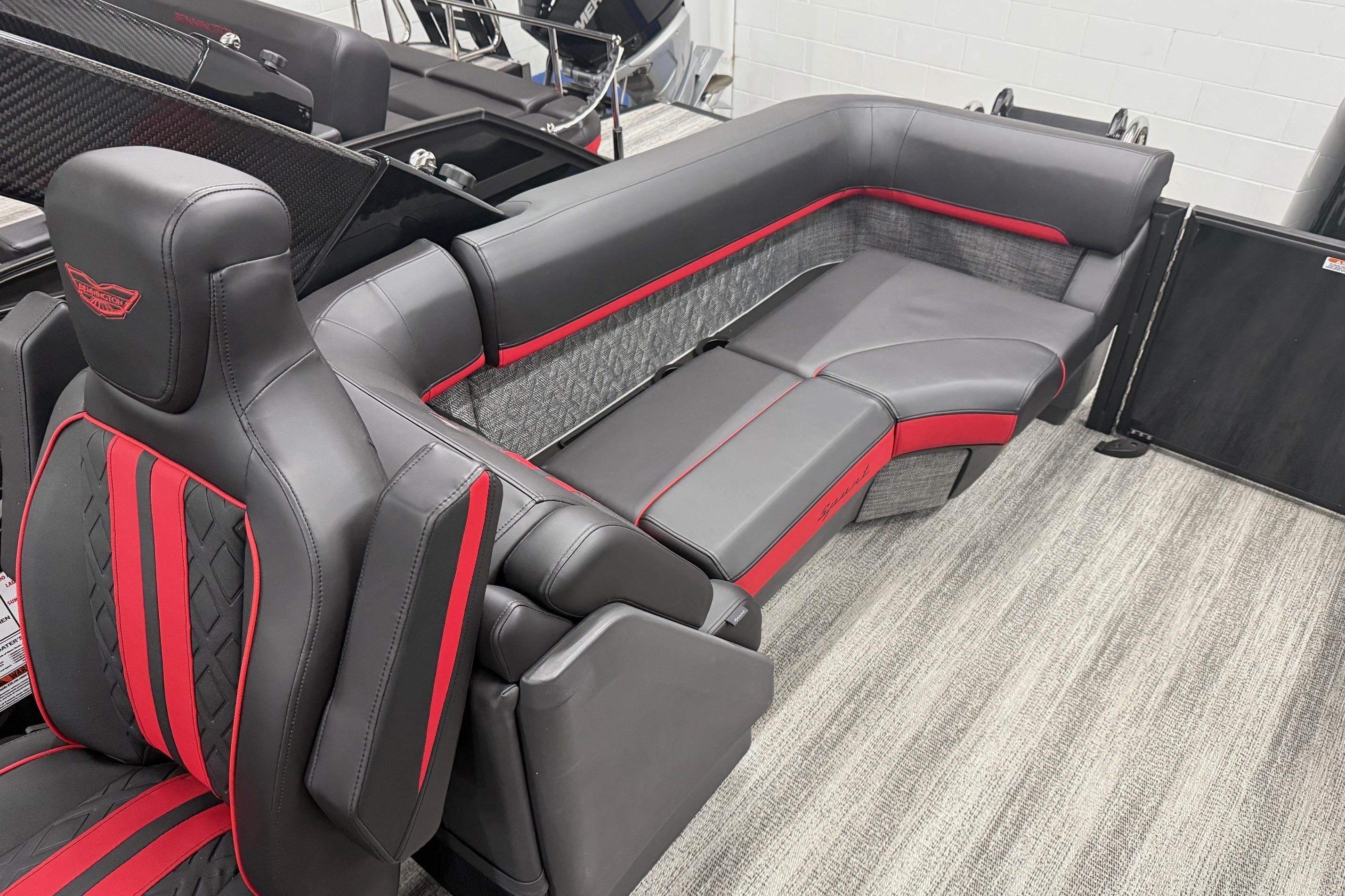 Luxurious 2025 Bennington M Line boat seating with sleek black and red upholstery design.