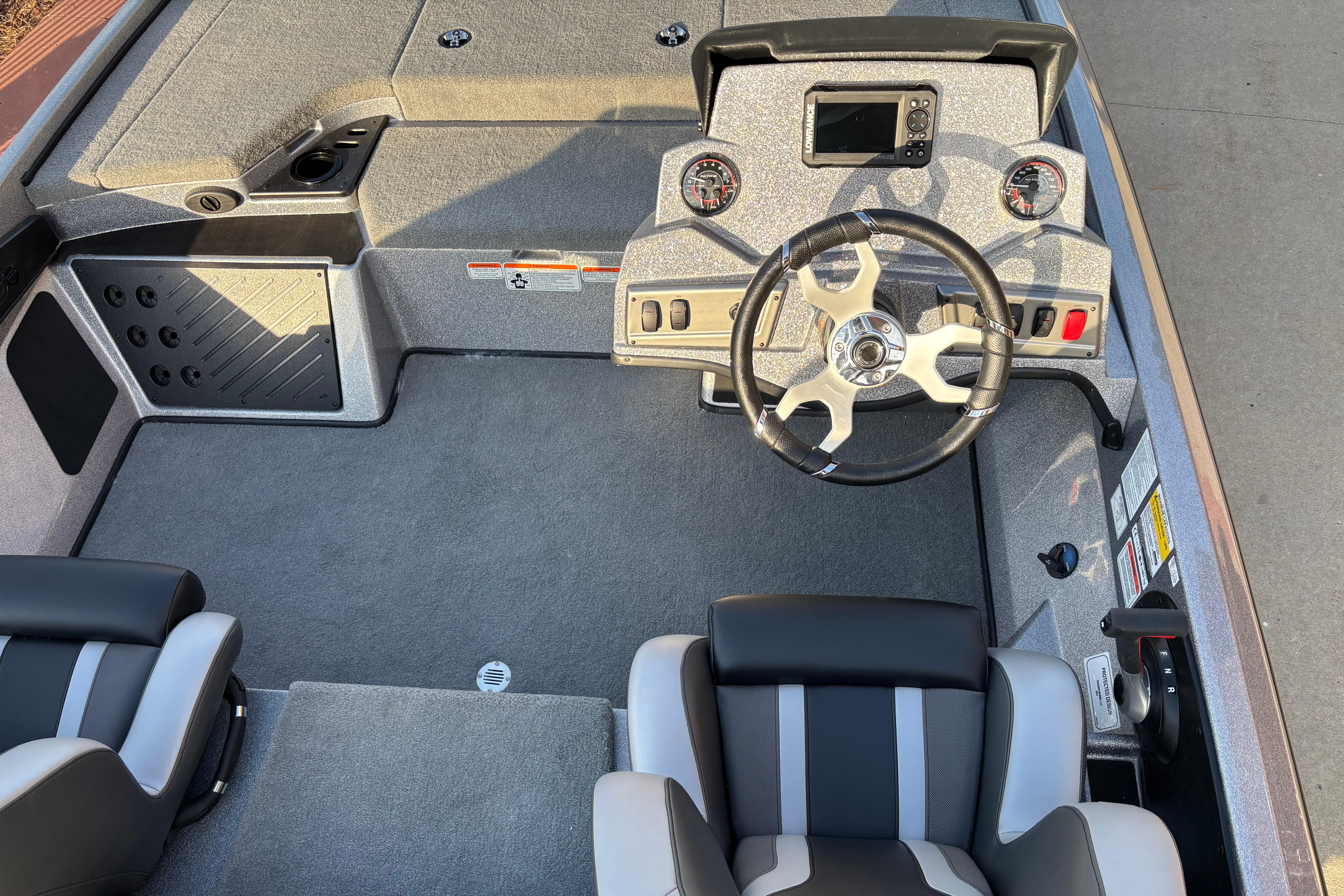 Interior of a 2026 Nitro Z18 boat featuring steering wheel and dashboard controls.