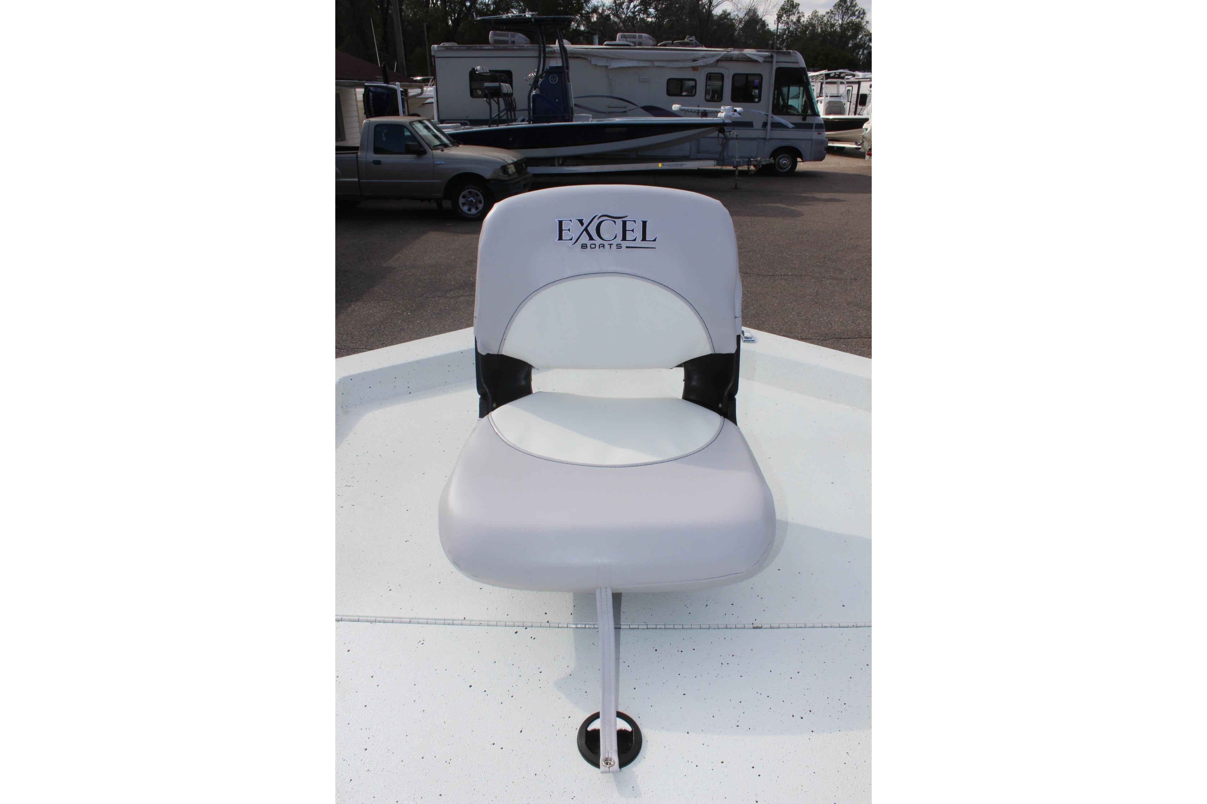 Captain's chair on 2025 Excel 2172 Stalker CC boat, parked with RVs in background.