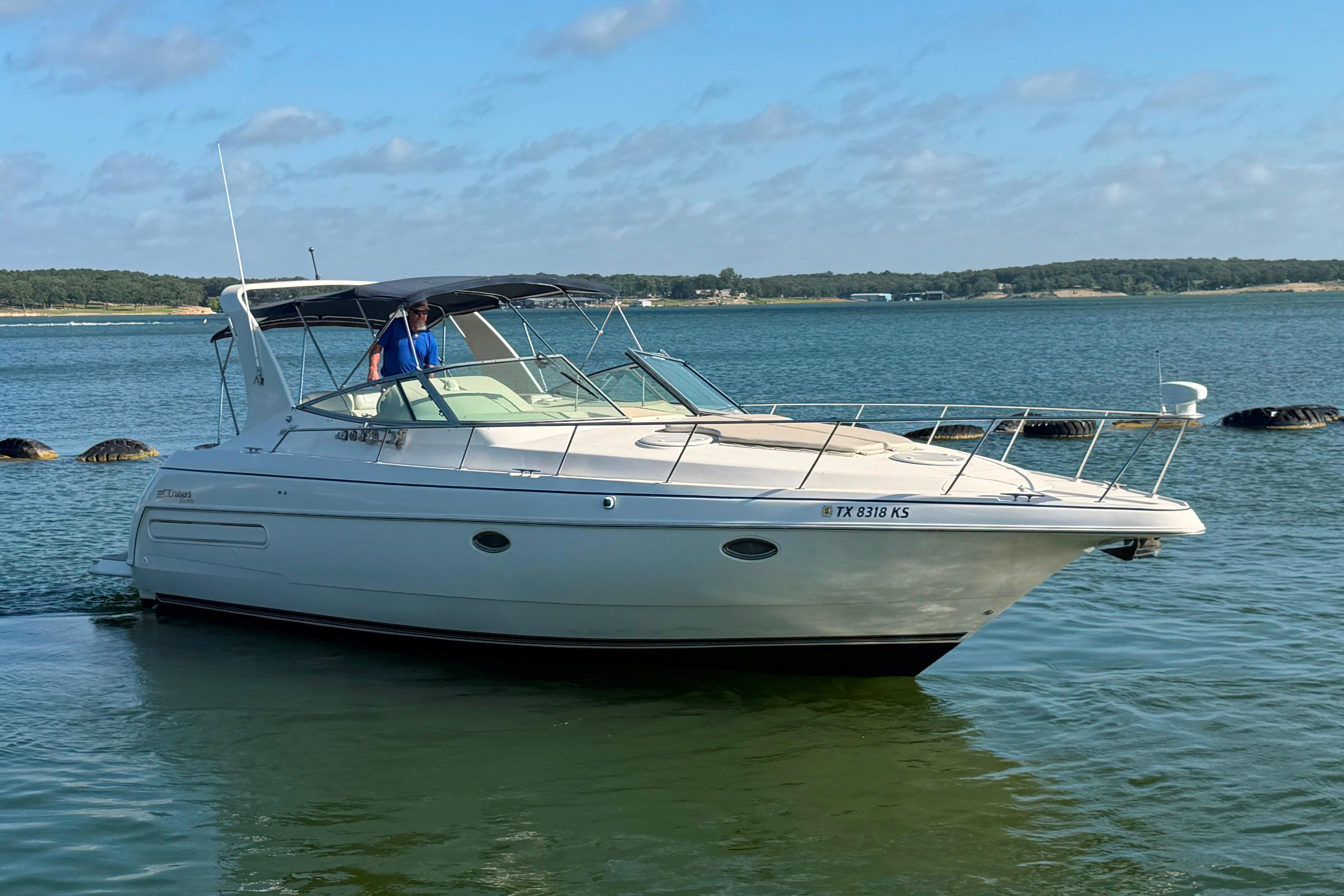 1997 Cruisers 3575 yacht on calm water, featuring sleek design and spacious deck.
