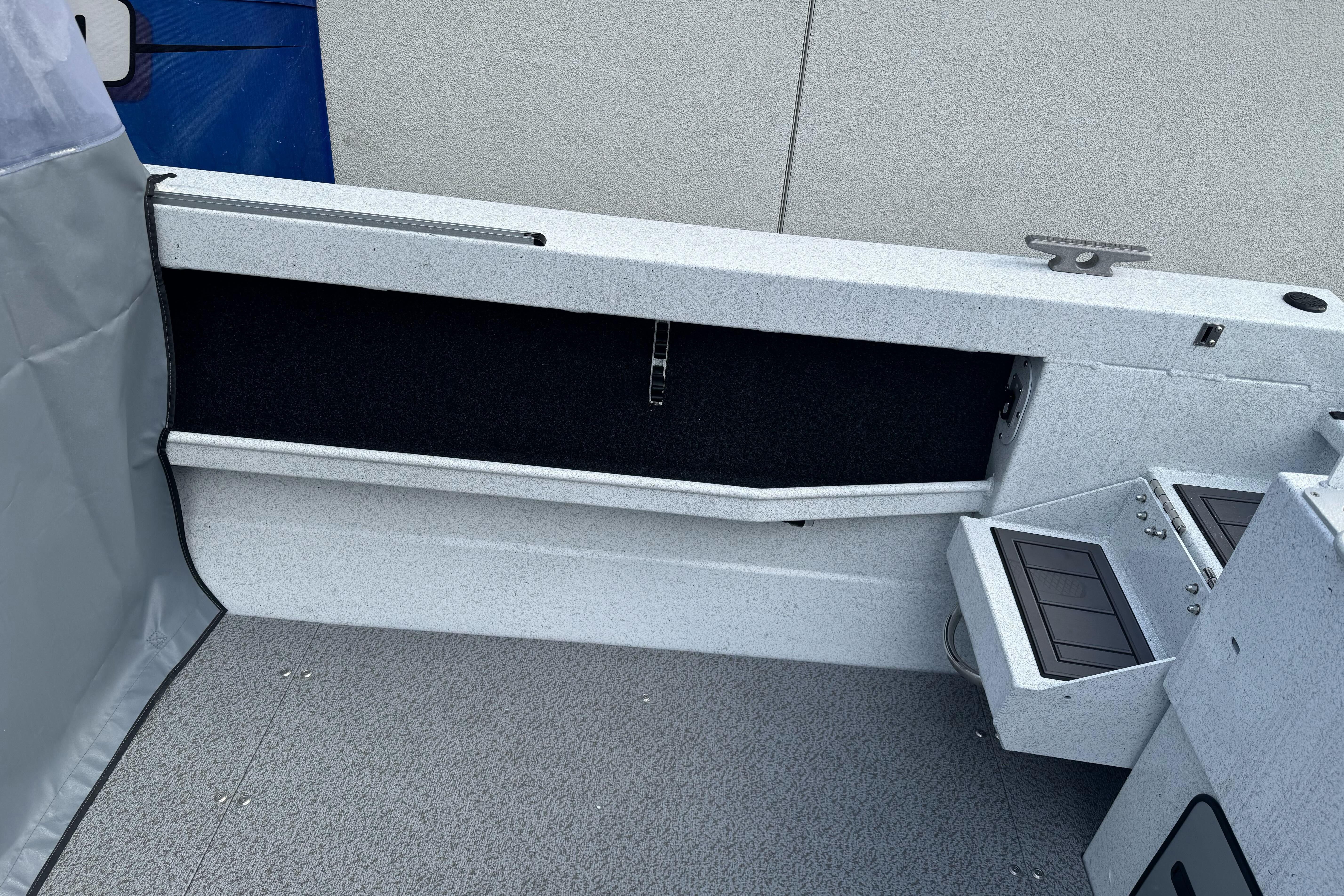 Interior view of 2026 KingFisher 2025 Escape boat, featuring storage compartments.