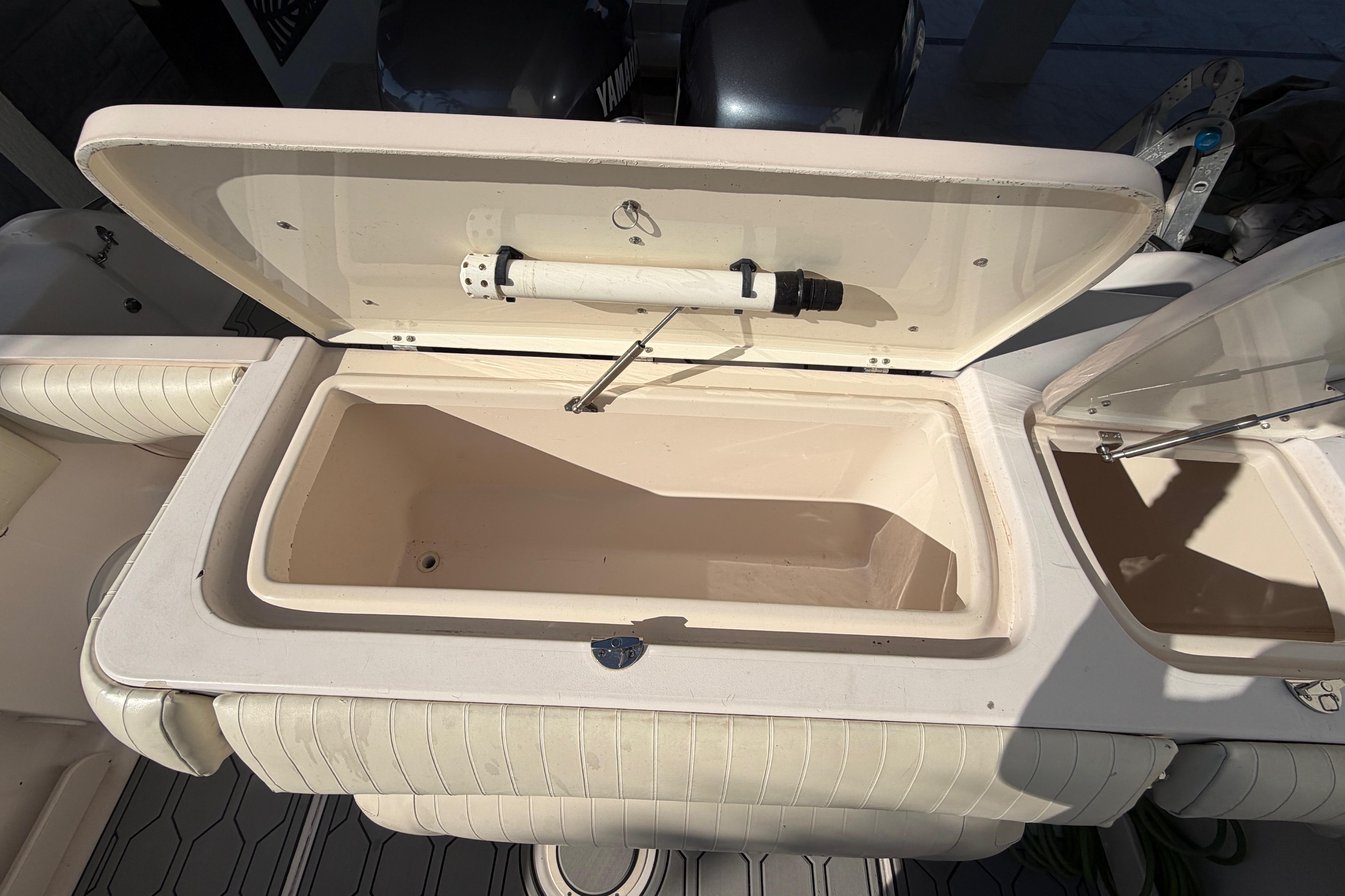 Open storage compartment on a 2004 Grady White 273 boat, showing interior details.