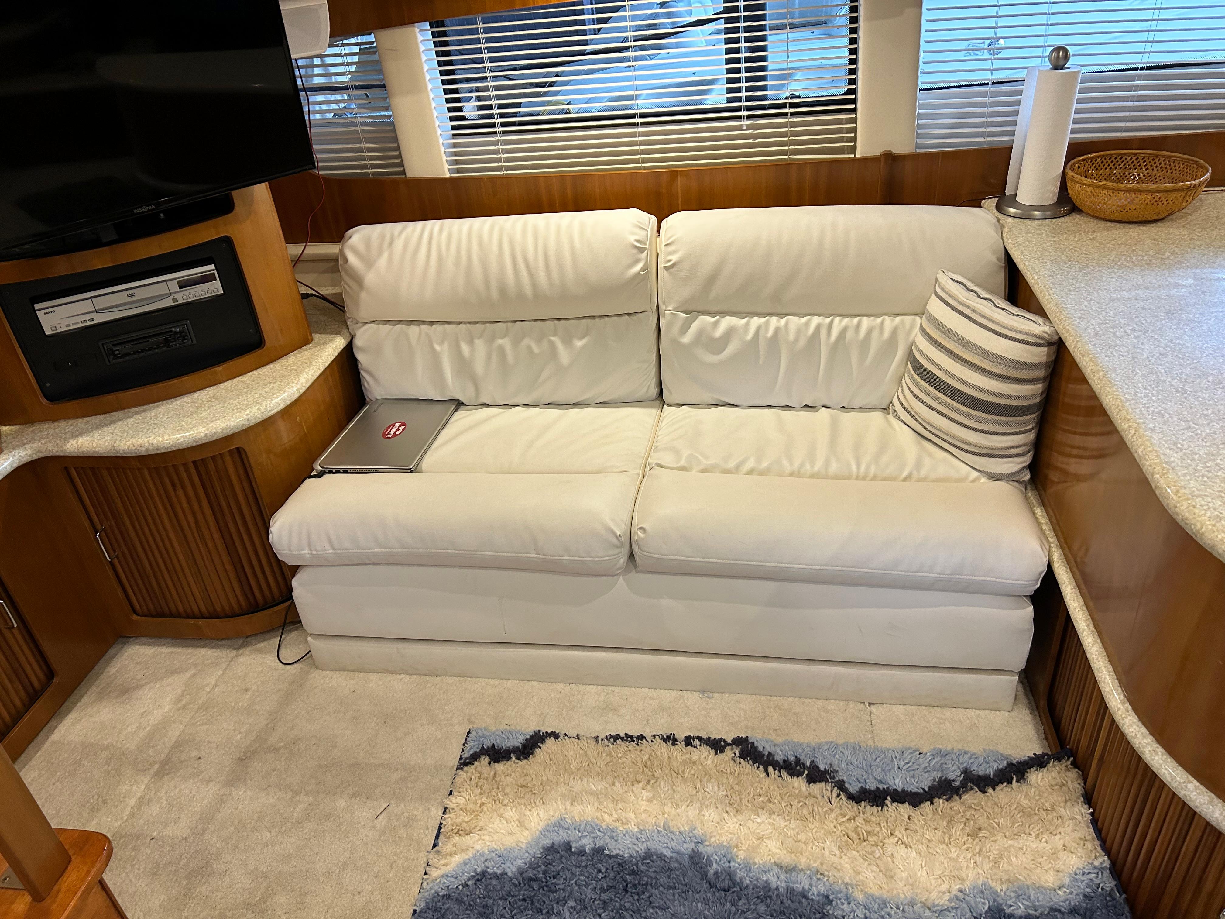 Interior of a 2000 Carver 396 yacht with a white sofa and modern decor.