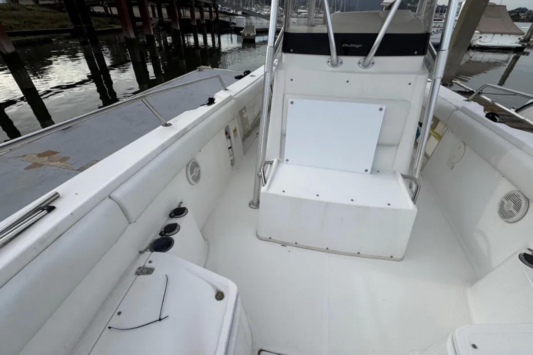 2001 Boston Whaler 26 Outrage boat interior, featuring seating and storage compartments.