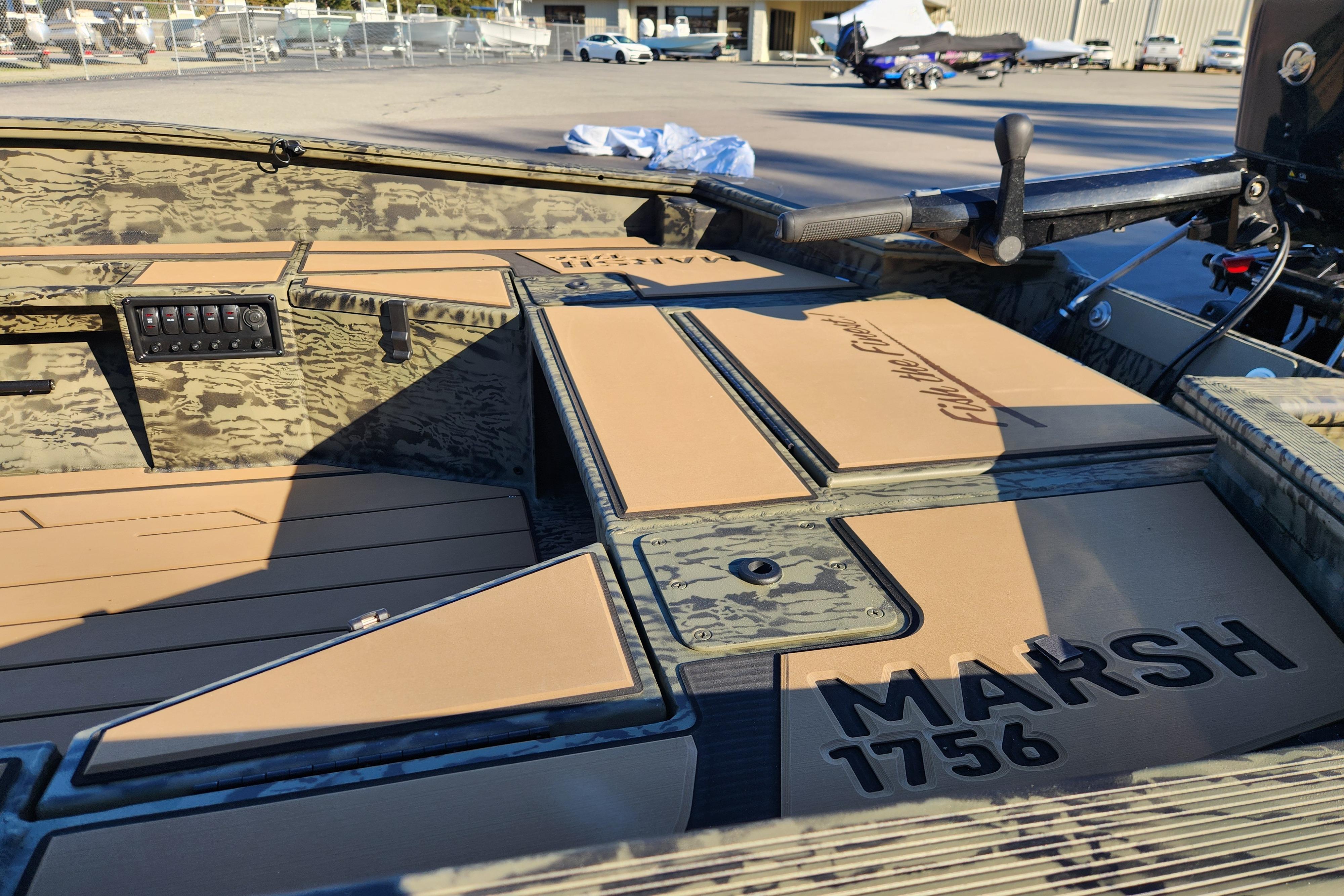 2026 Tracker Grizzly 1756 T Marsh boat interior with camouflage design and control panel.