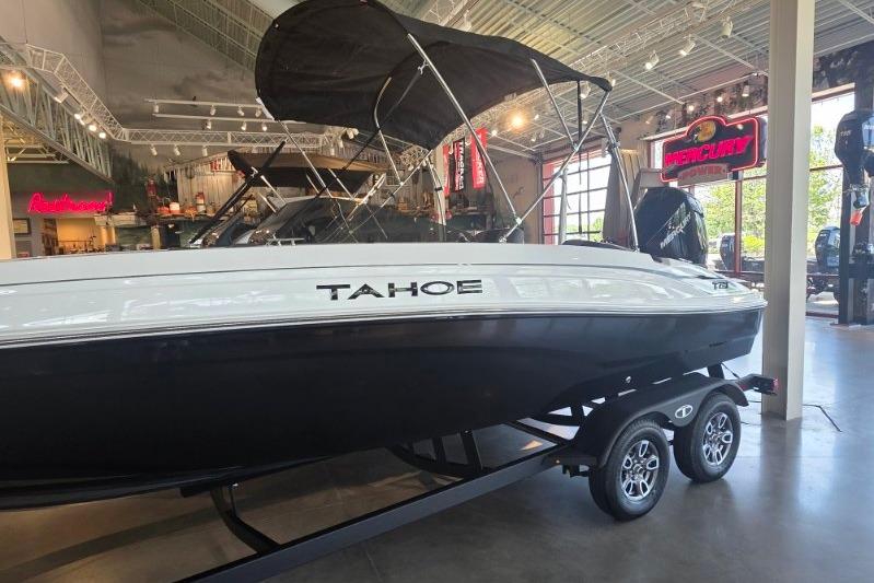 2026 Tahoe T21 boat displayed indoors with sleek black and white design.