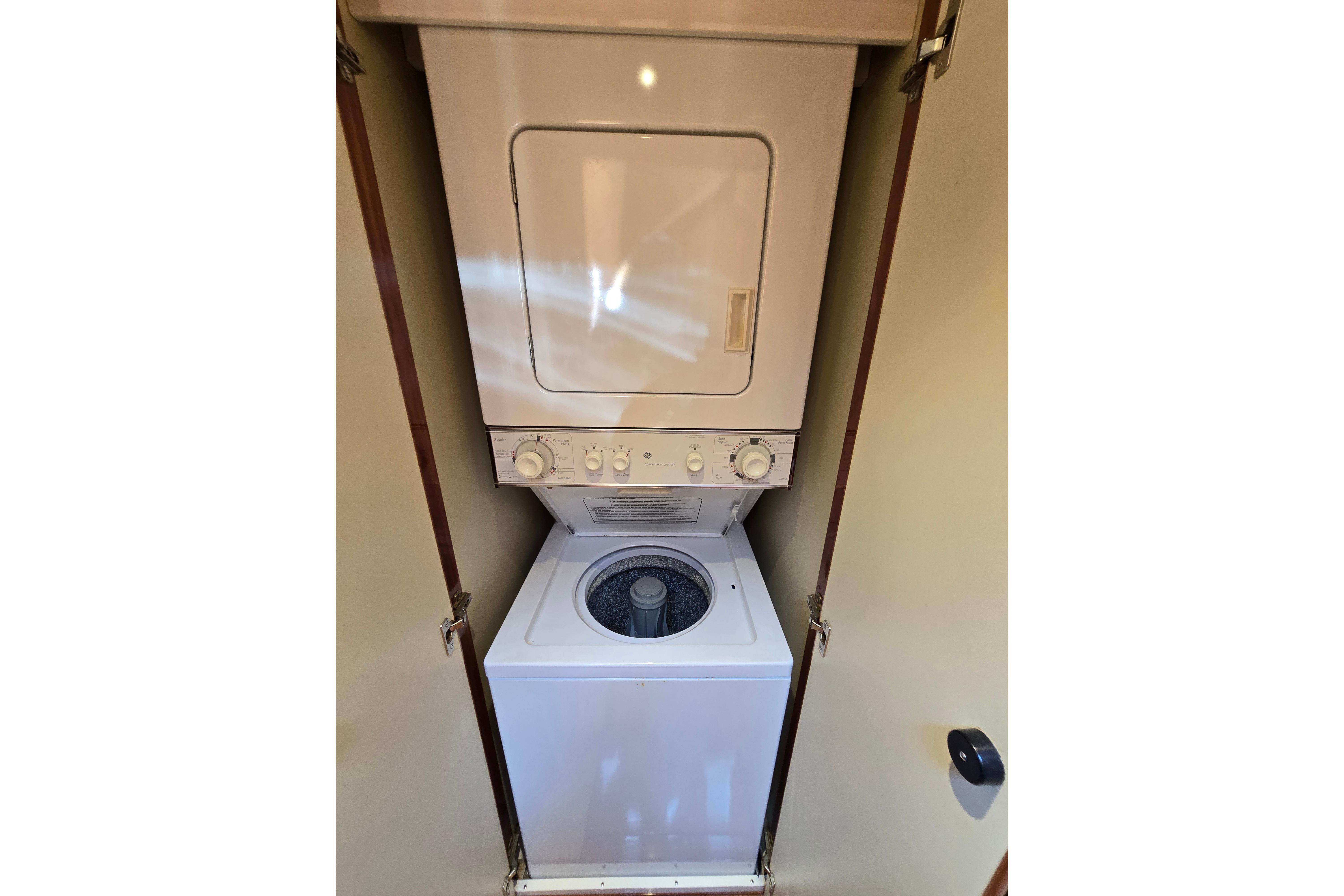 Stacked washer and dryer unit inside a 2004 Grand Harbour 58 yacht.
