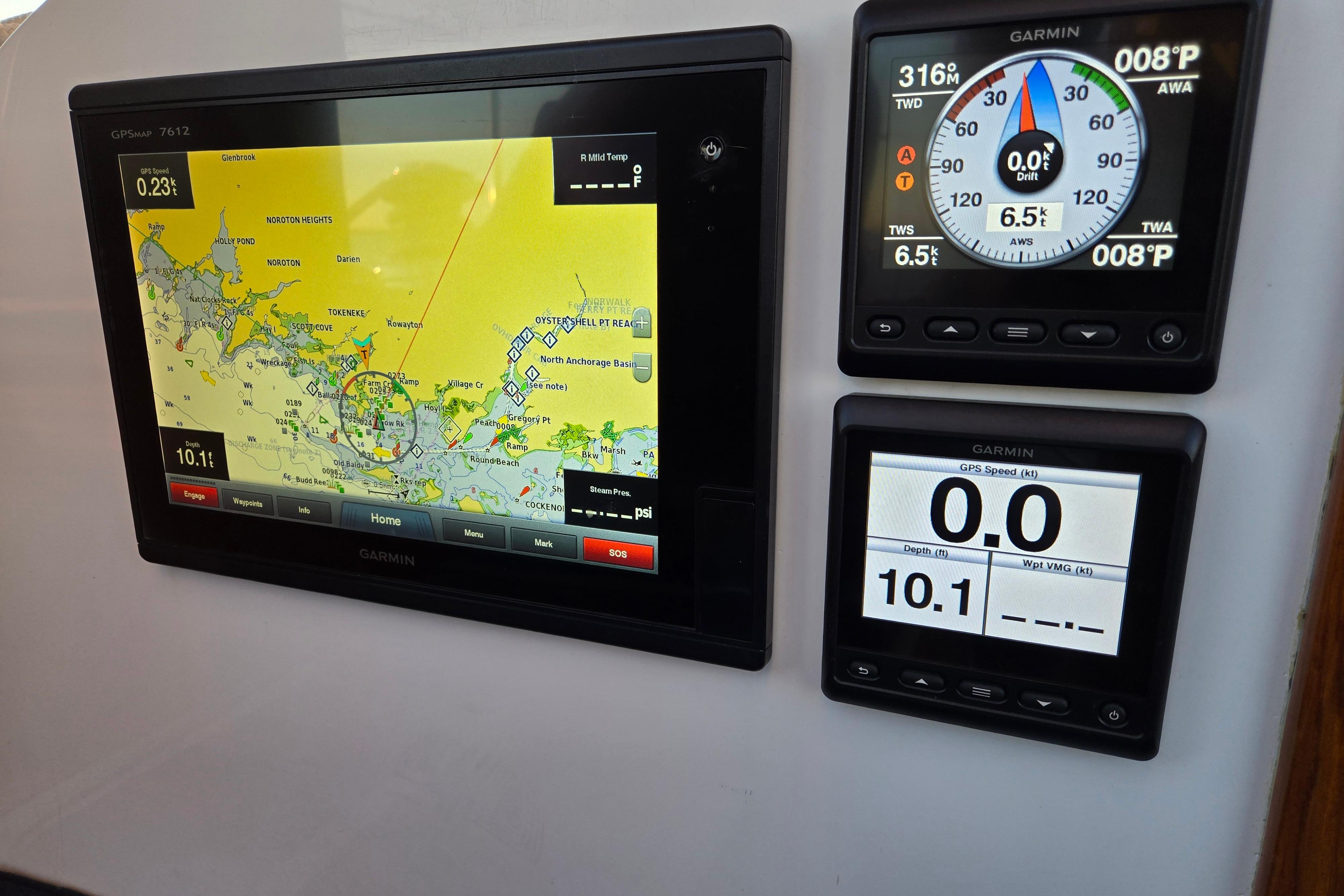 Garmin navigation displays on a 1970 Hinckley Bermuda 40 sailboat, showing maps and sailing data.