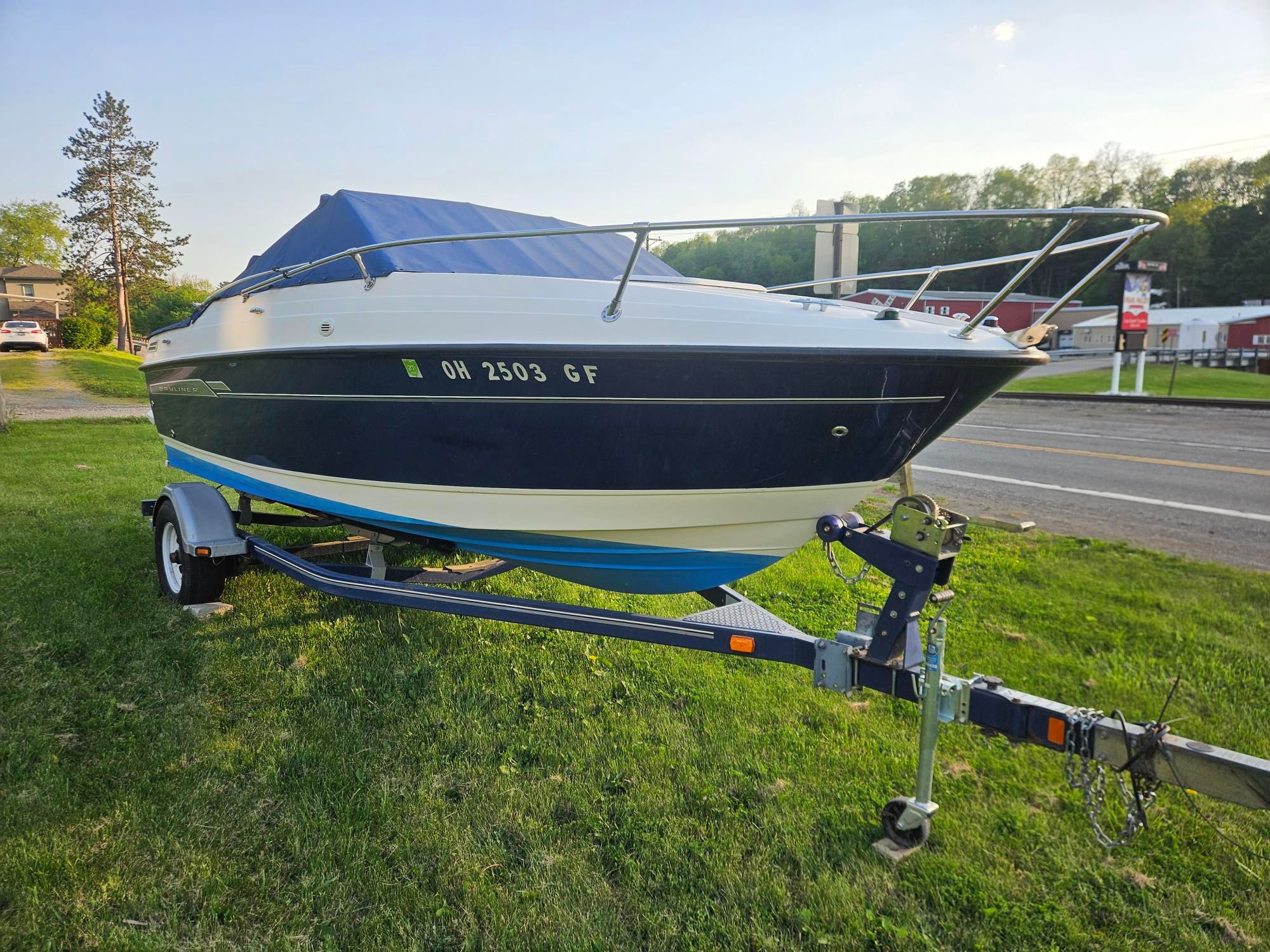2006 Bayliner Cuddy Cab on trailer, side view.