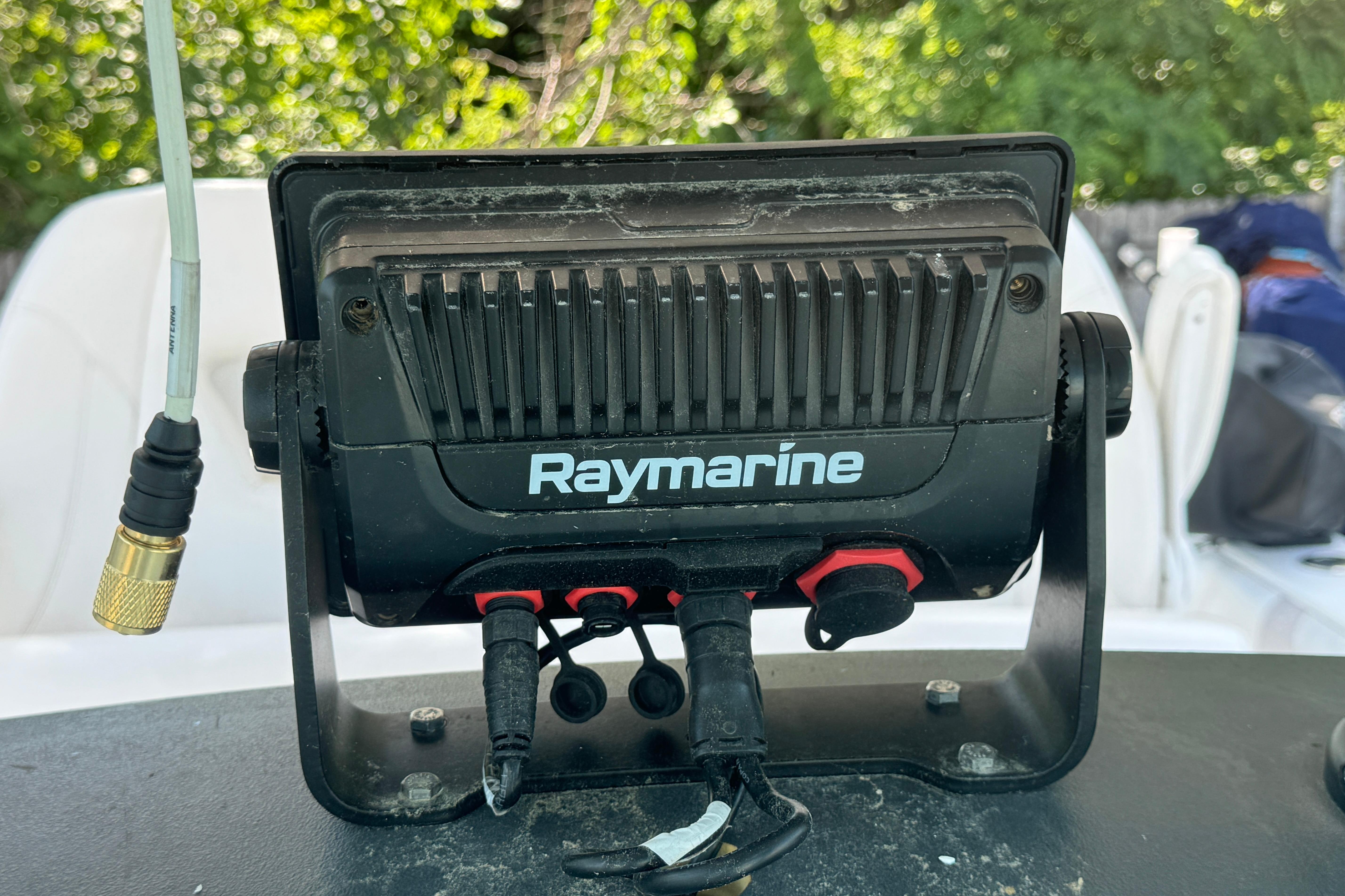 Raymarine device on 2014 Boston Whaler 250 Outrage boat, surrounded by greenery.