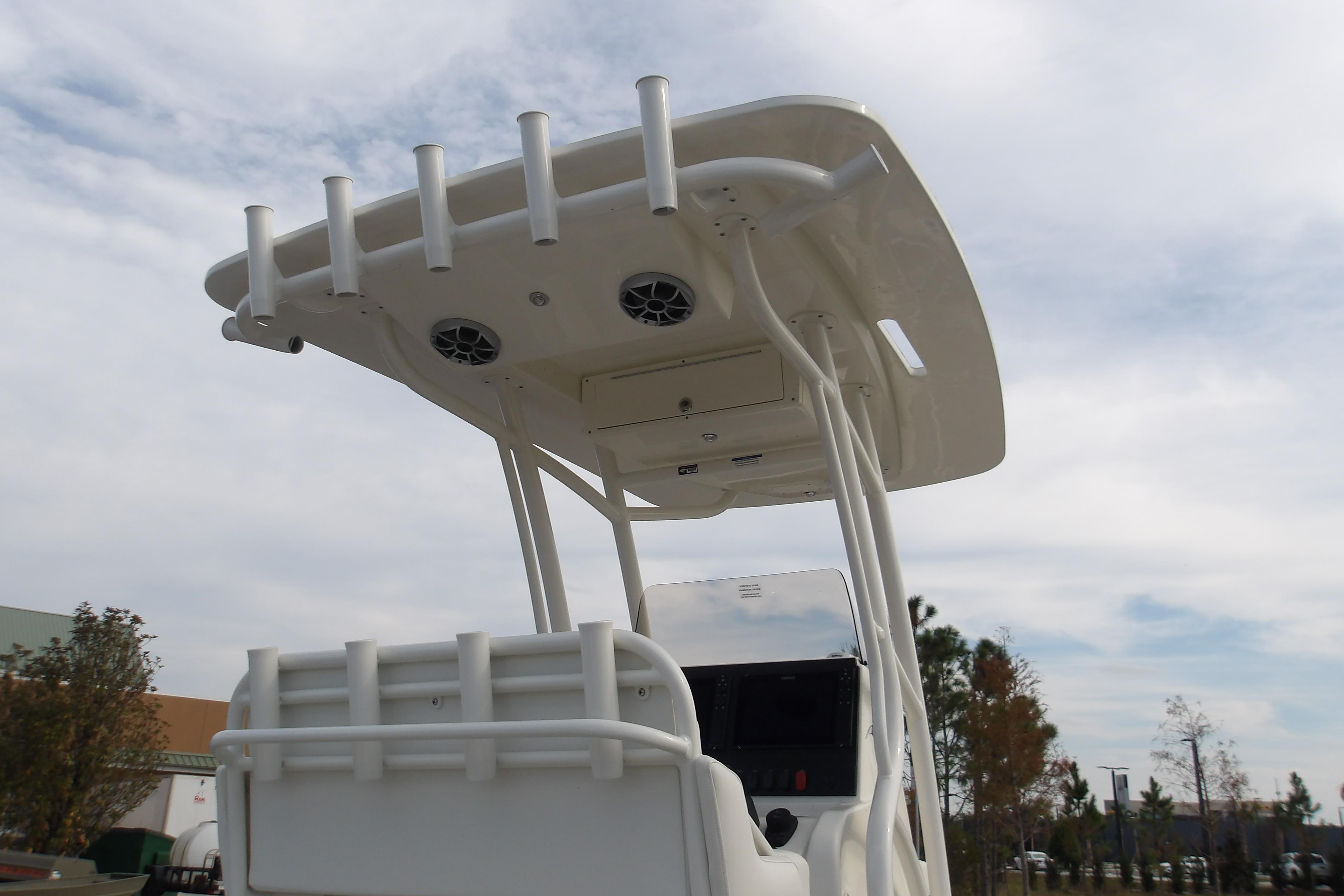 2026 Mako 24 APEX boat with T-top and rod holders under cloudy sky.