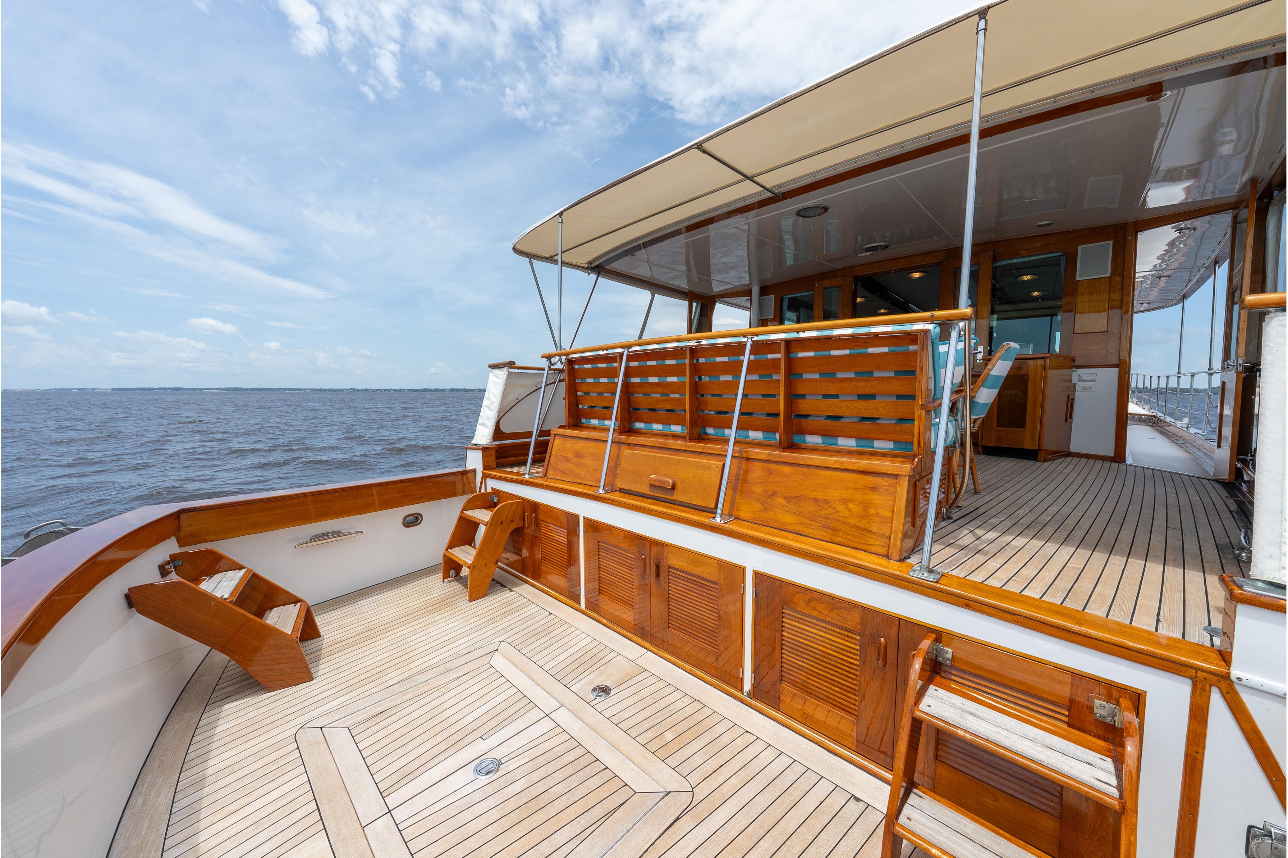 1963 Trumpy Classic yacht deck with elegant wood finish and ocean view.