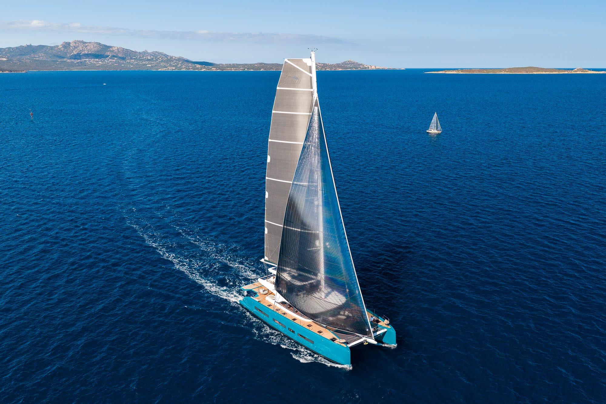 2026 Lagoon Eighty 2 catamaran sailing on open blue sea.