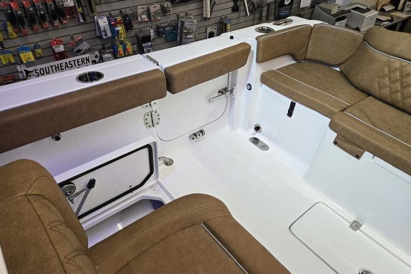 Interior of 2026 Sea Hunt Ultra 275 Coffin Box boat with tan seating and storage.
