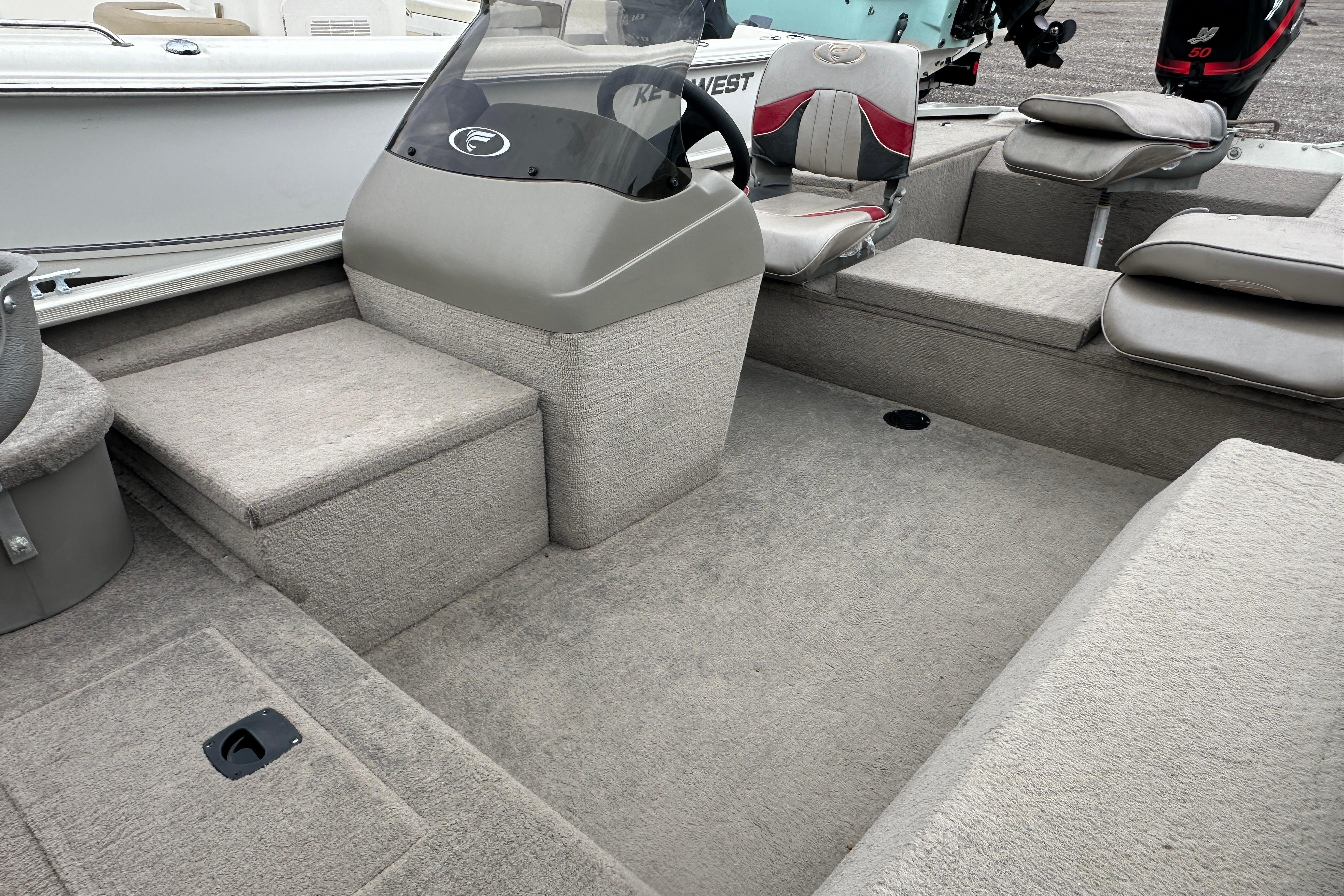 Interior of a 2002 Fisher 1710 boat with gray seating and steering console.