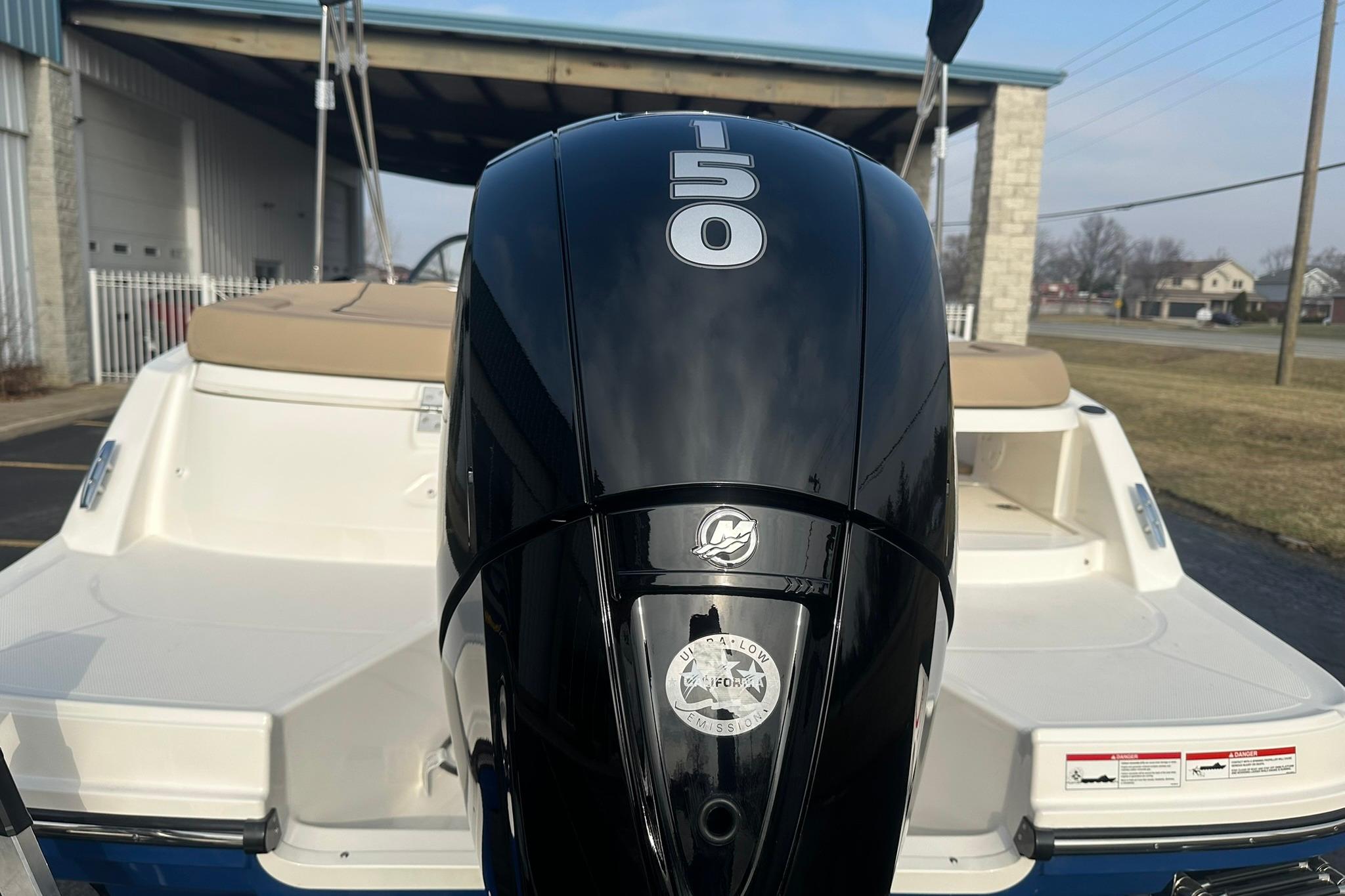 2026 Bayliner VR6 Bowrider OB with 150 HP outboard motor, parked outdoors.