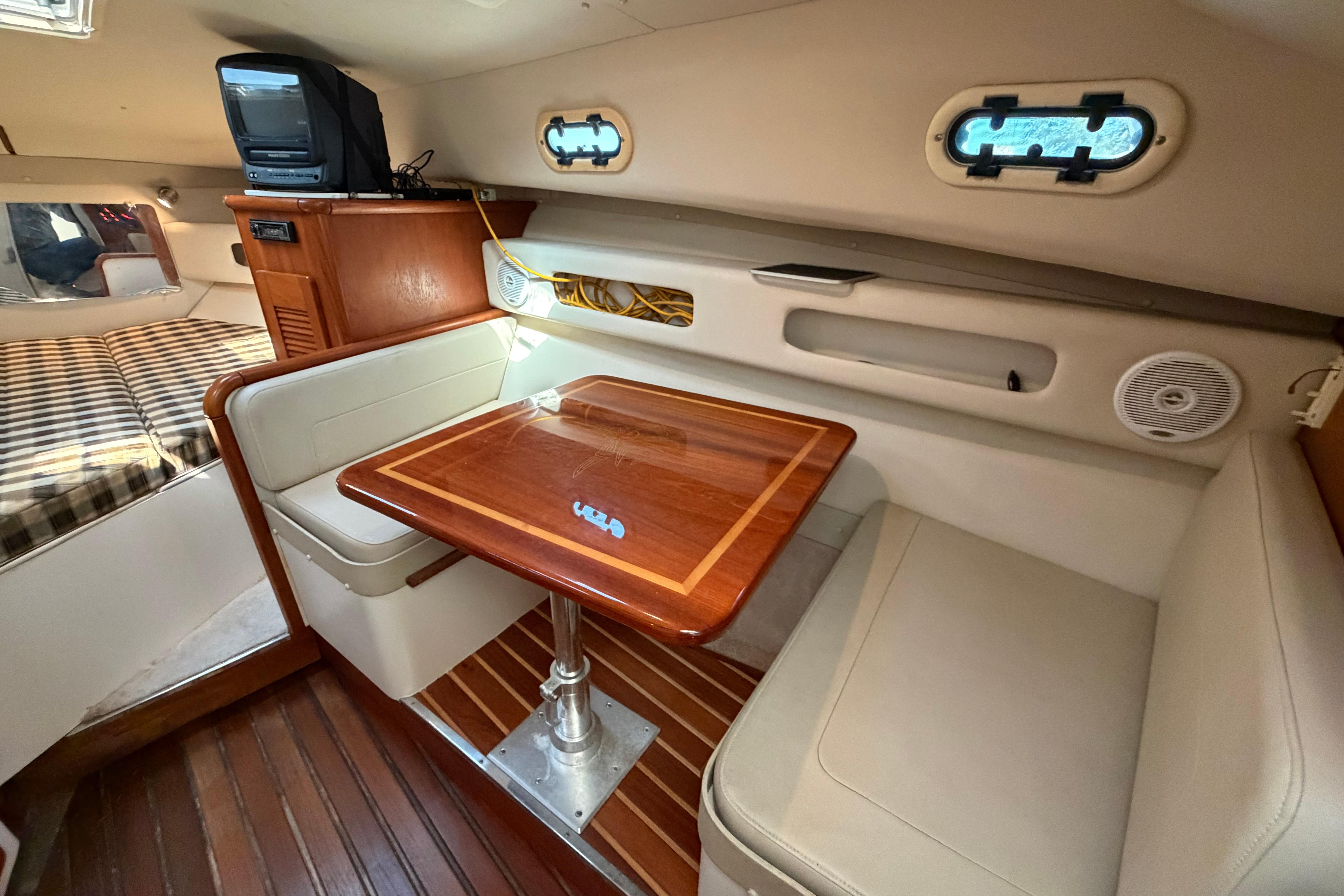 2001 Pursuit 3000 Express cabin interior with dining area and cozy seating.