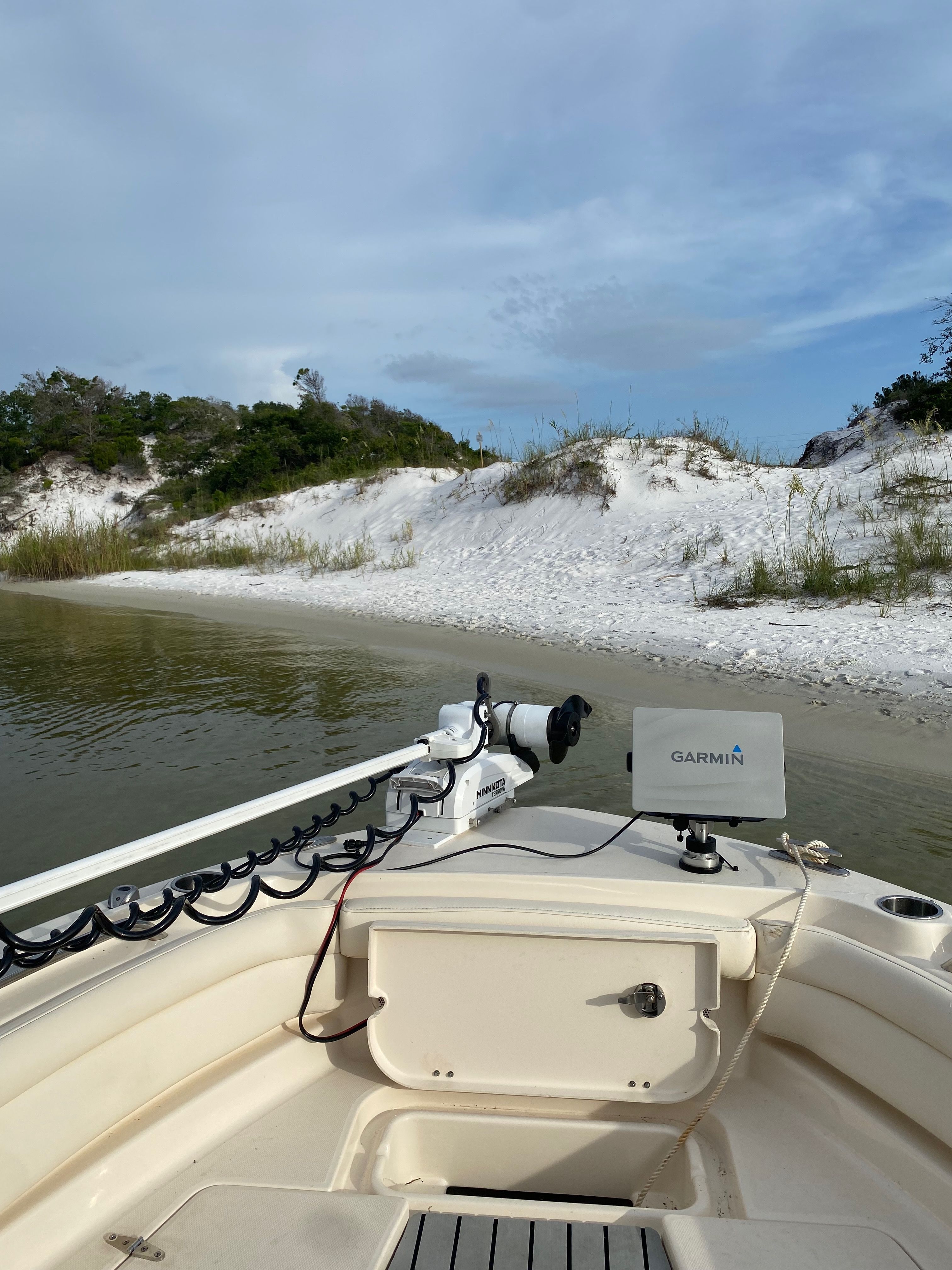 2018 Grady-White Freedom235 boat near sandy shore with Garmin equipment.