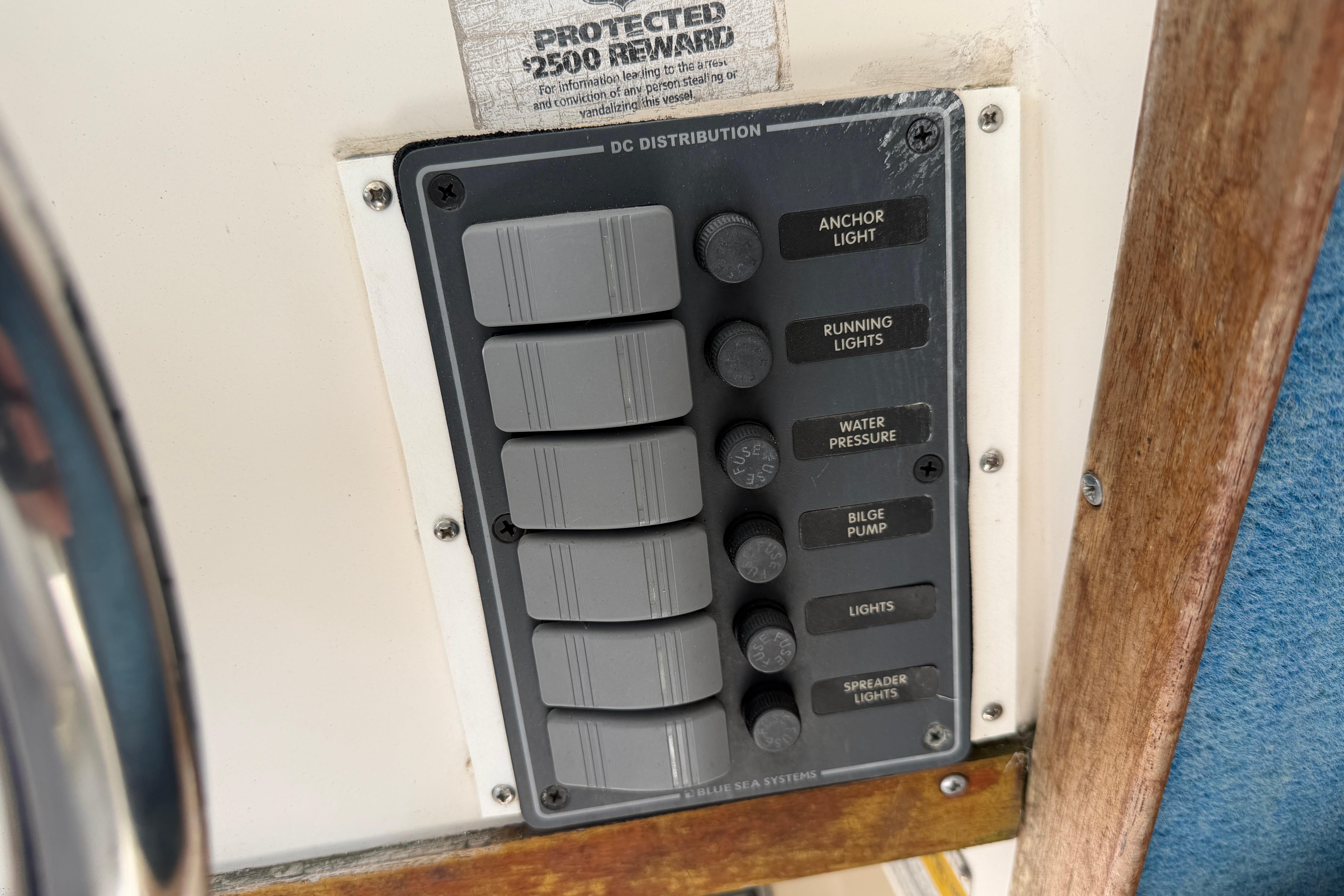 Control panel on a 1987 Grady-White Seafarer 226 boat, featuring various switches.