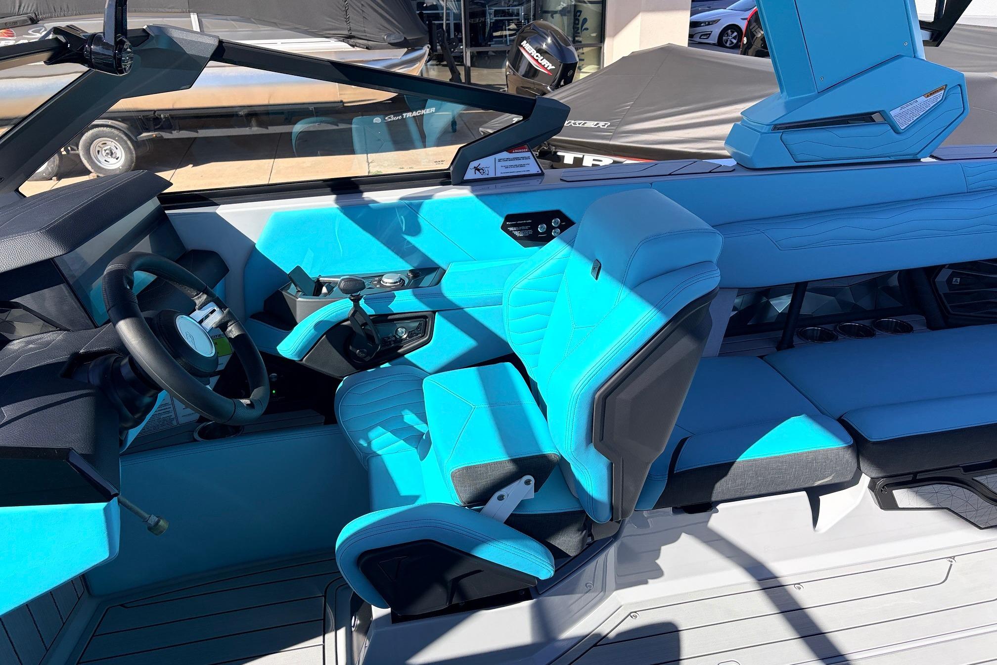 Interior of 2026 Nautique Super Air Nautique G23, featuring vibrant blue seating and modern controls.