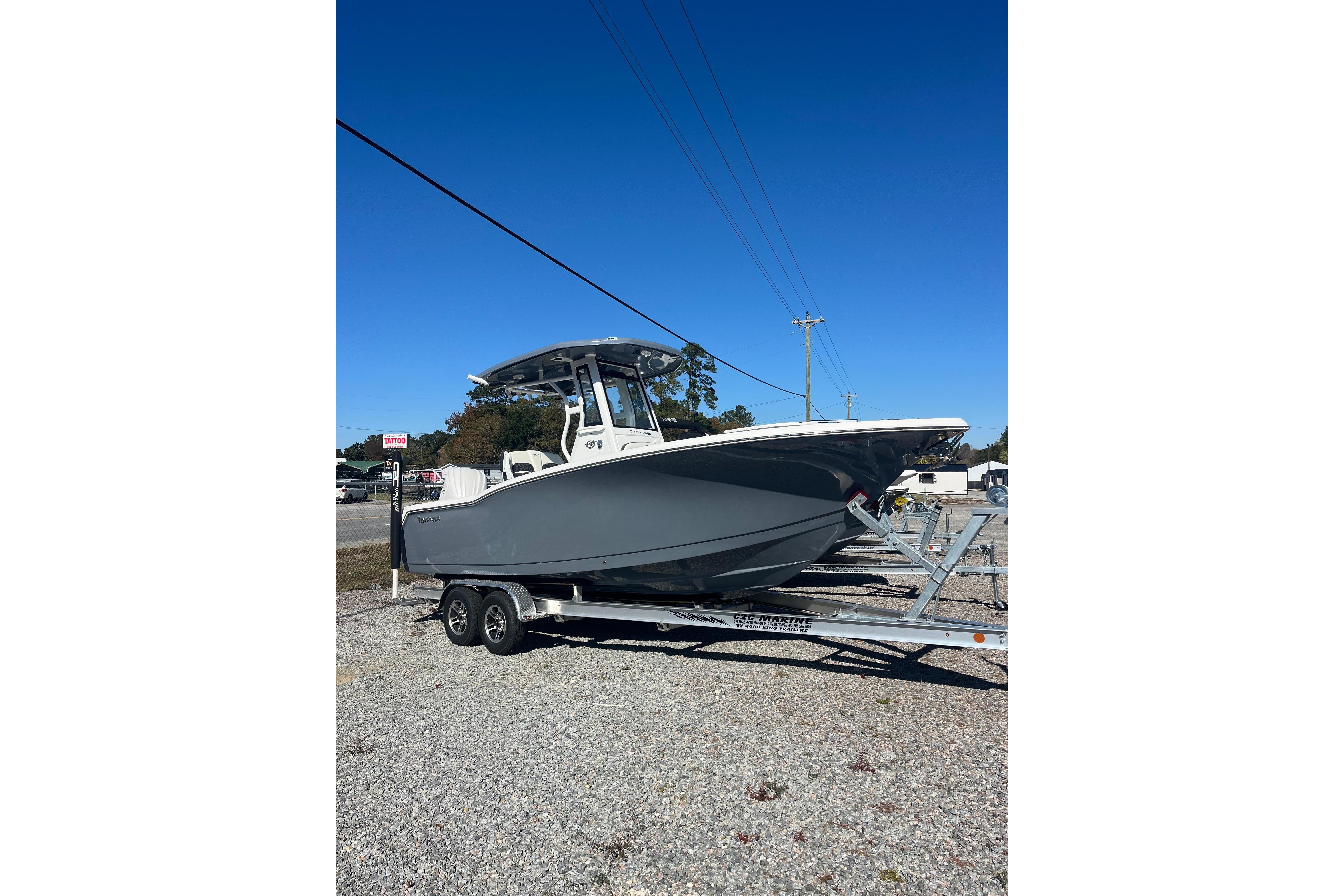 2026 Tidewater 232 CC Adventure boat on trailer under clear blue sky.
