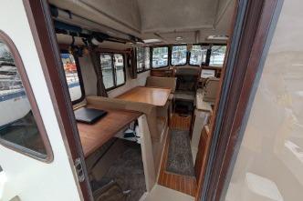 Interior of 2008 Ranger 25 featuring seating and wooden accents.