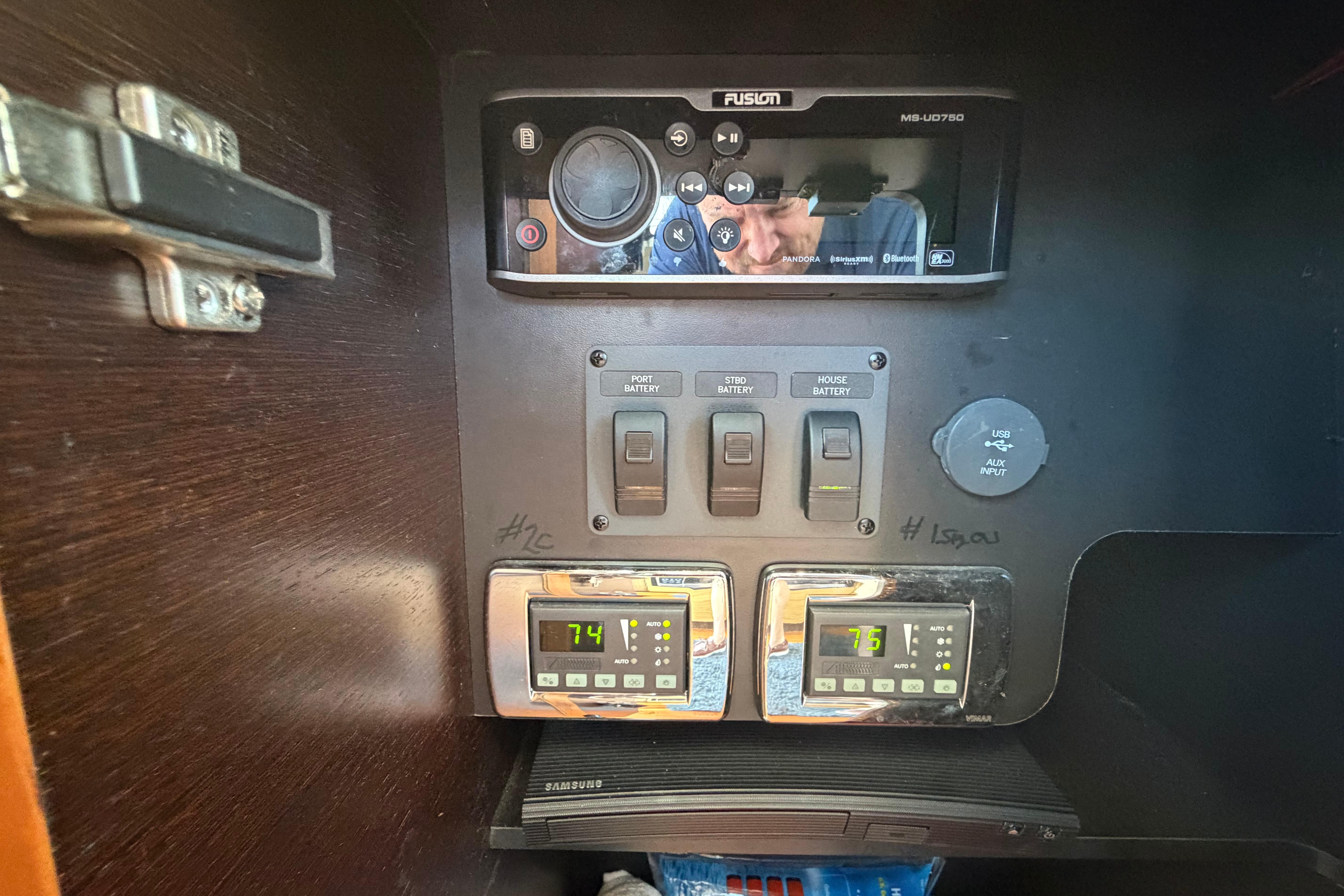 Control panel of a 2016 Tiara Yachts C39 Coupe with temperature displays and audio system.