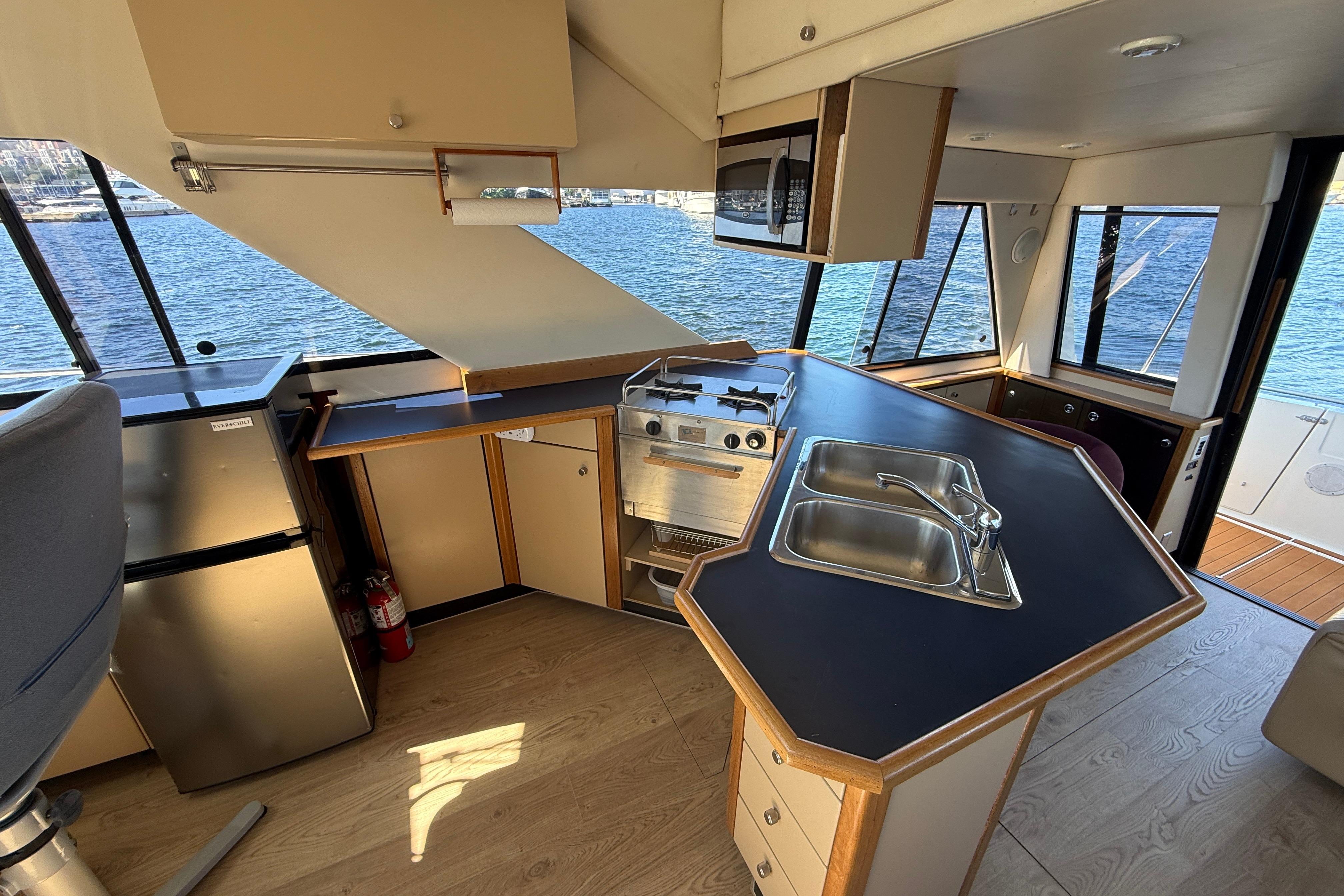 Interior of 1997 Bayliner 3988 Command Bridge Motoryacht with kitchen and scenic water view.