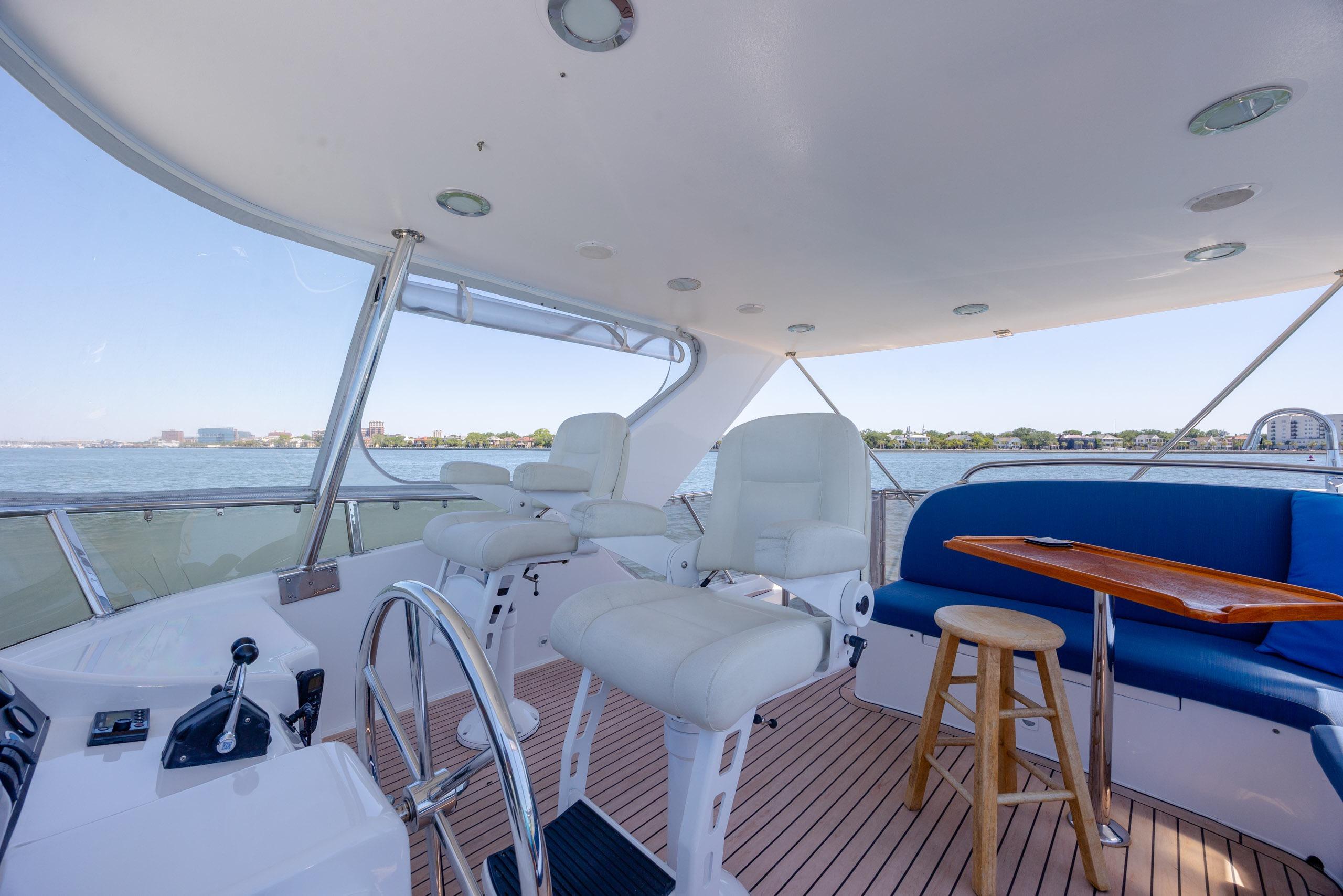 Luxurious 2005 Ocean Alexander 52 Sedan yacht interior with seating and scenic water view.