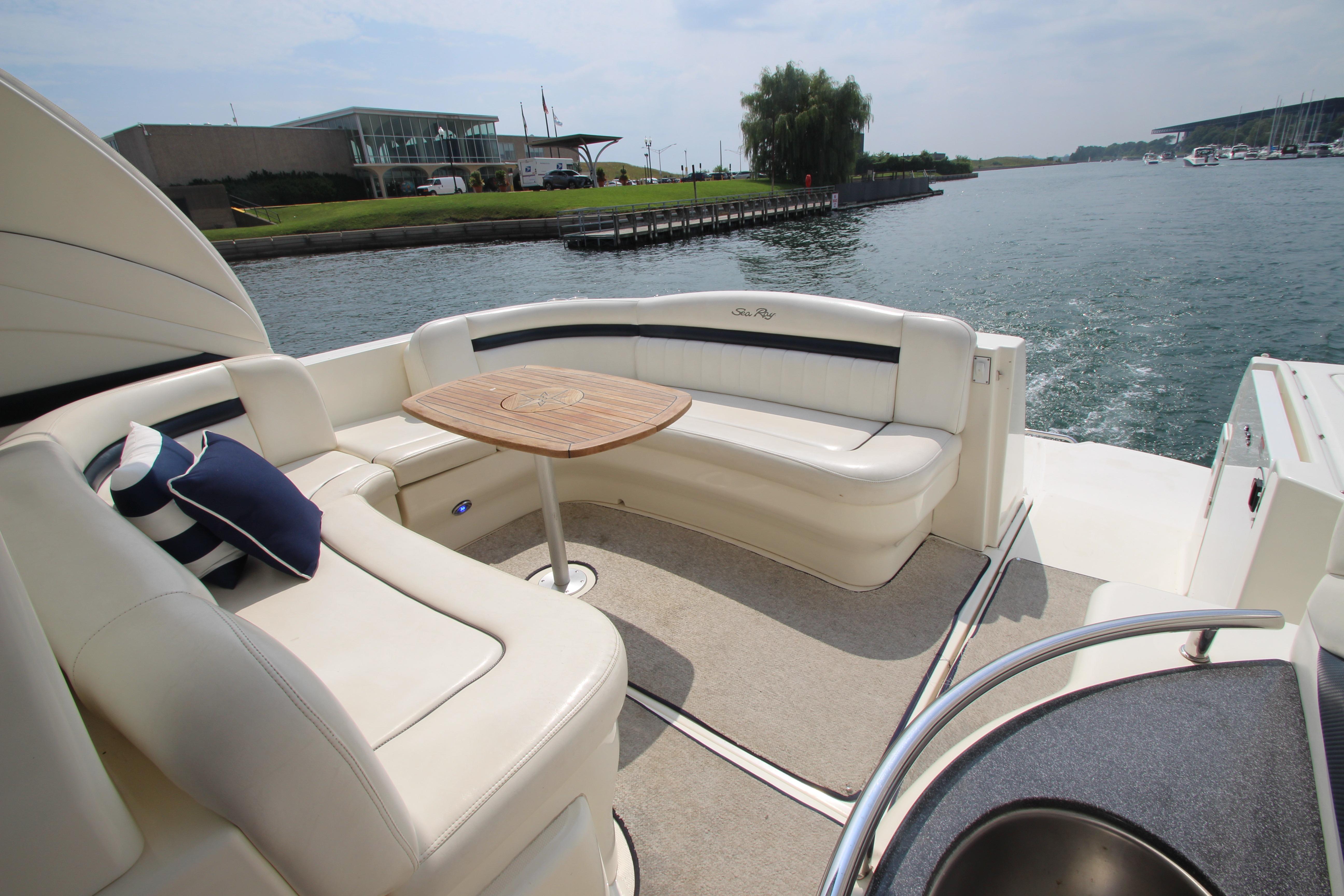 2004 Sea Ray 40 Sundancer yacht with elegant seating and table on deck.