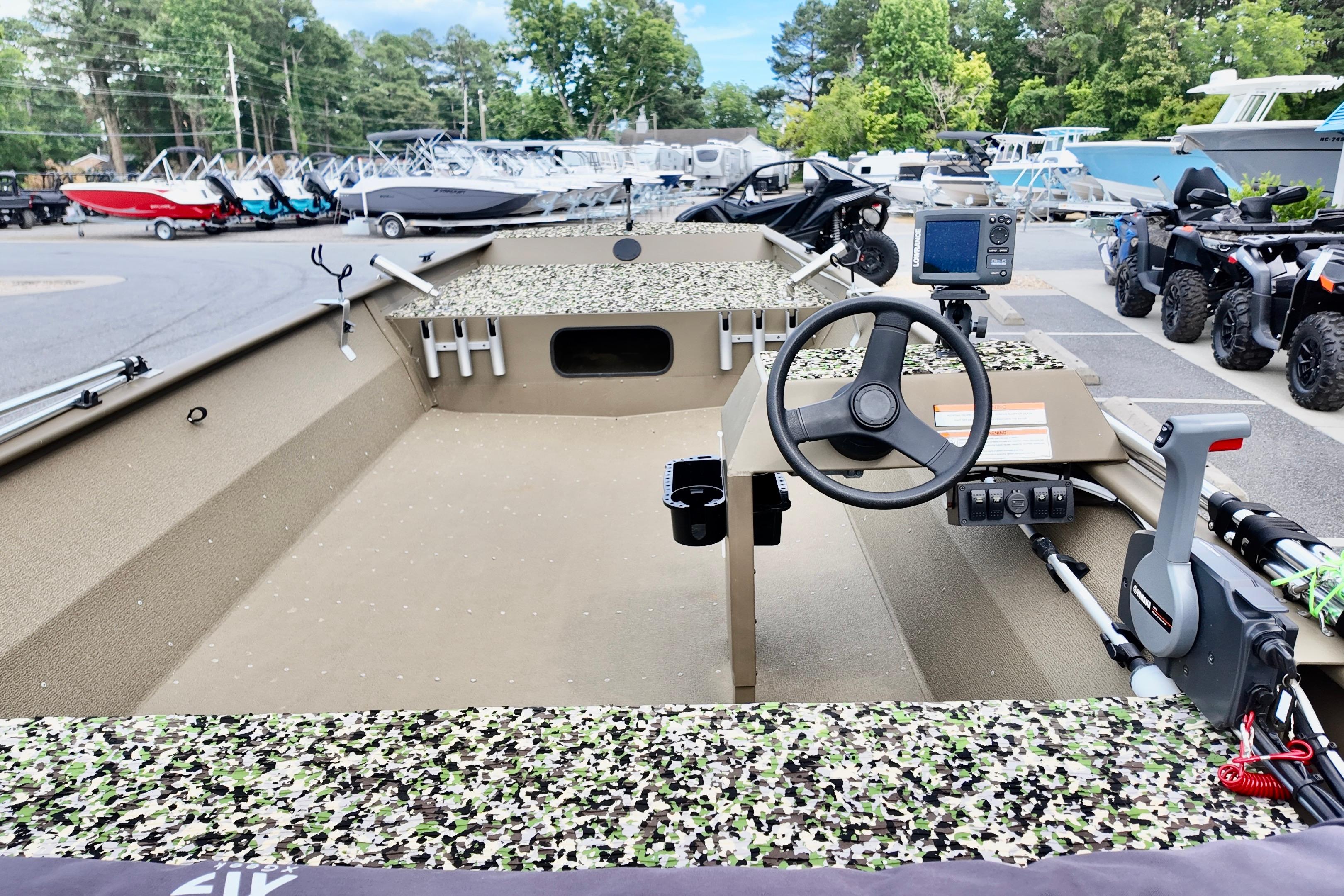 2025 G3 BOATS 1860 SC fishing boat with camouflage interior, steering wheel, and control panel.
