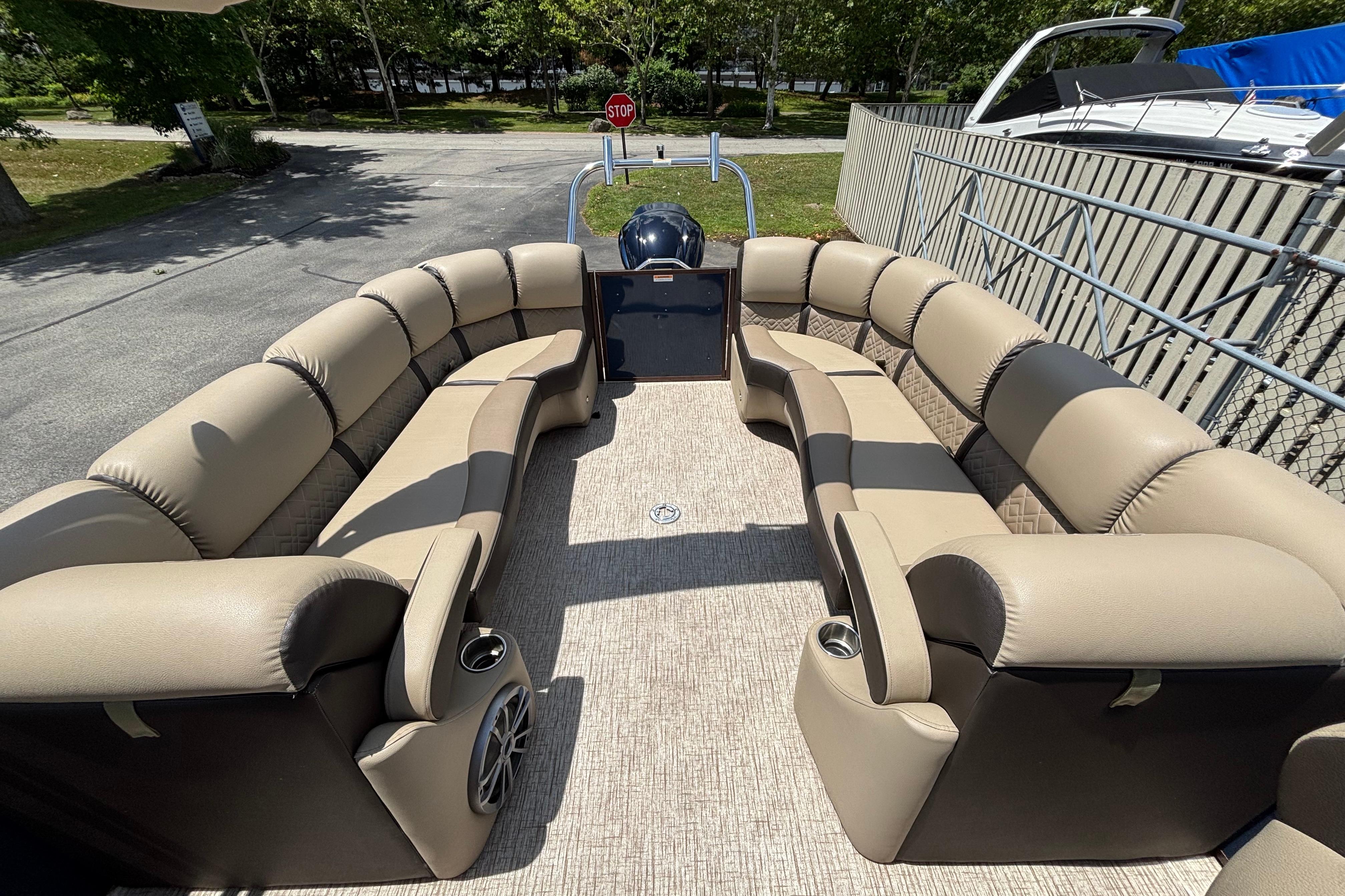 Luxurious seating on a 2021 Veranda VP25RC pontoon boat, parked outdoors.