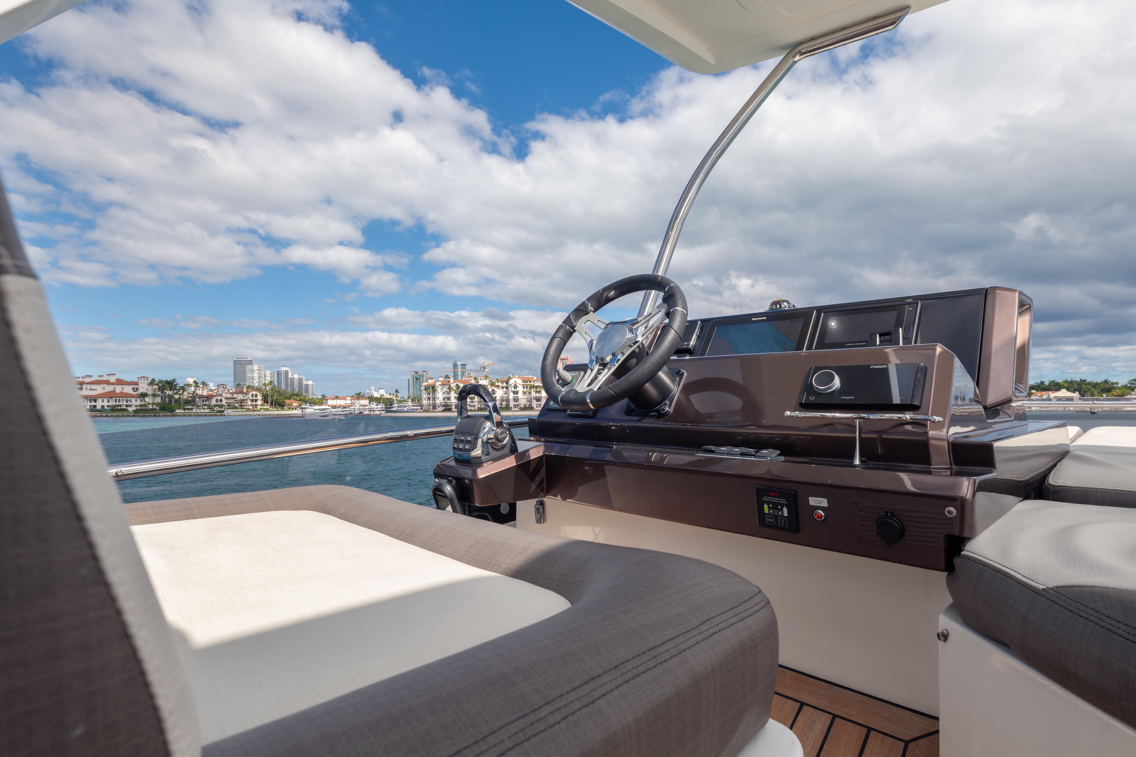 2020 Galeon 500 Fly yacht helm with scenic waterfront view.