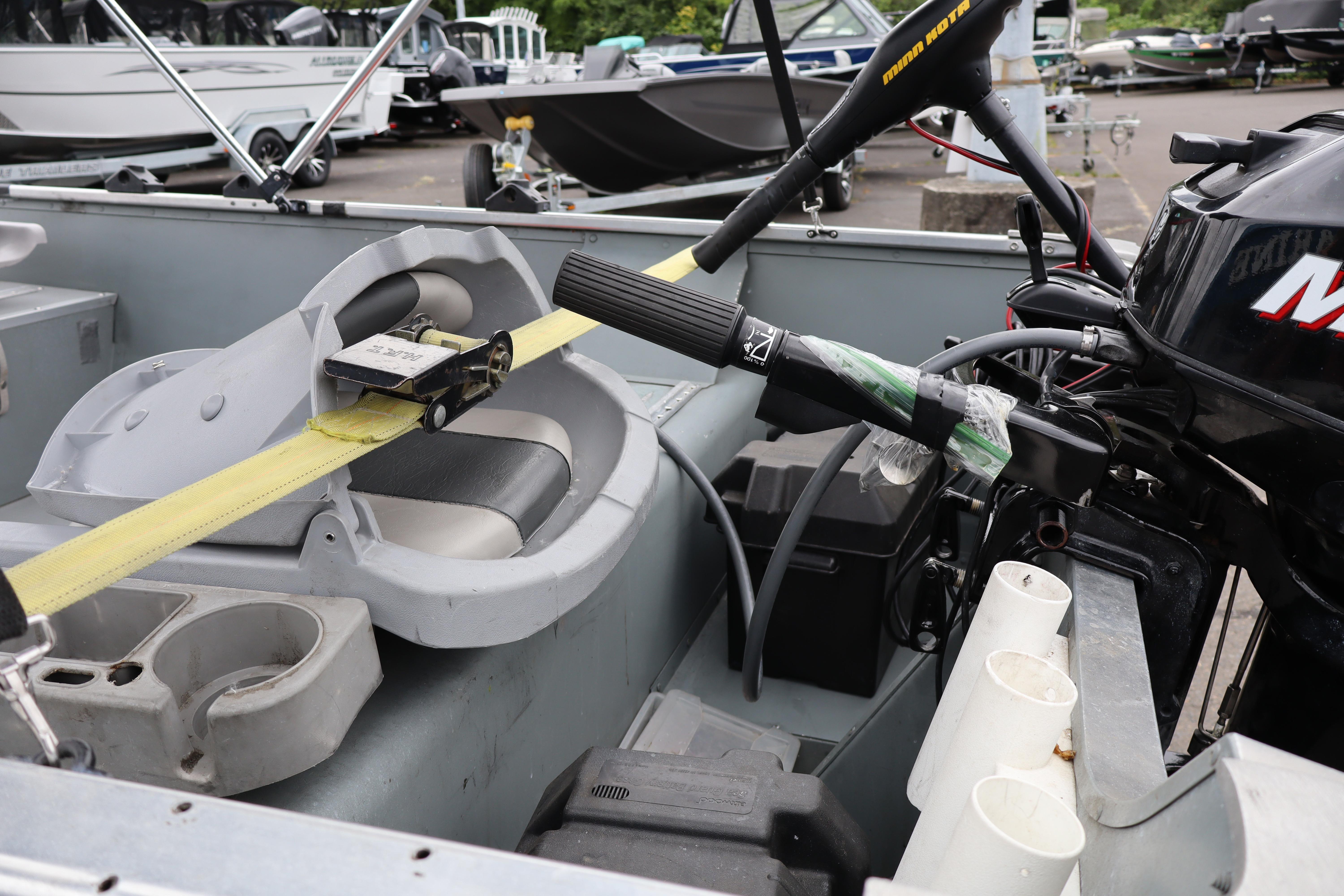 2006 Smoker Craft Alaskan 15 boat interior with motor and seating details.