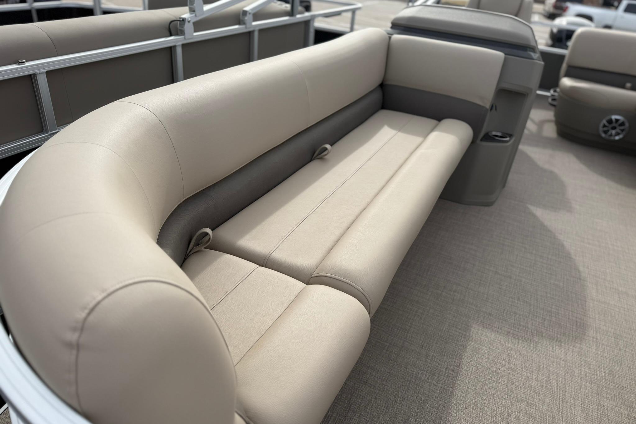 2025 Sun Tracker Party Barge 18 DLX pontoon boat with beige seating.