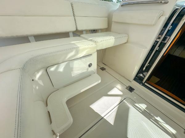 2006 Tiara Yachts 3200 Open interior with white seating and storage compartment.
