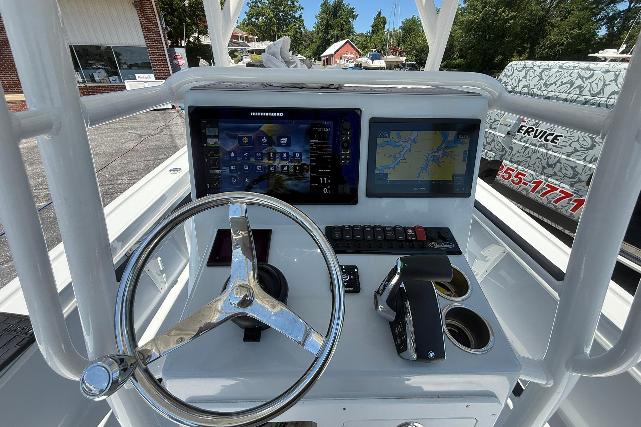 2024 Pair Customs 24 Center Console MV dashboard with steering wheel and navigation screens.