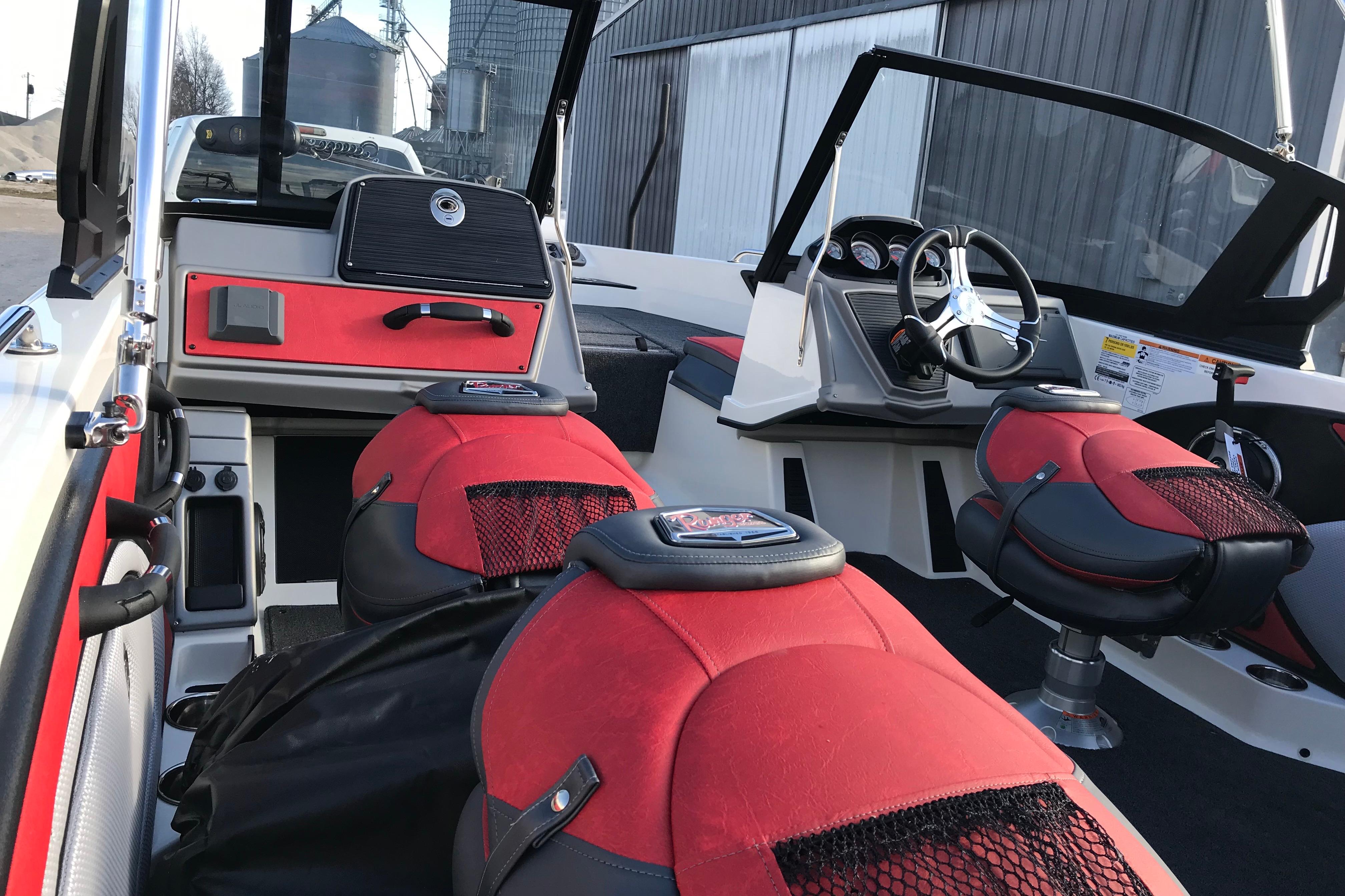 2026 Ranger 1850MS boat interior with red and black seating, steering wheel, and dashboard.